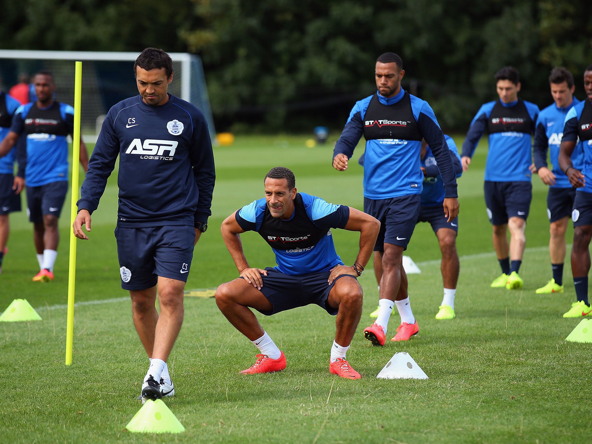 New QPR signing Rio Ferdinand (centre, during training) is expected to play a pivotal role as sweeper in the new system