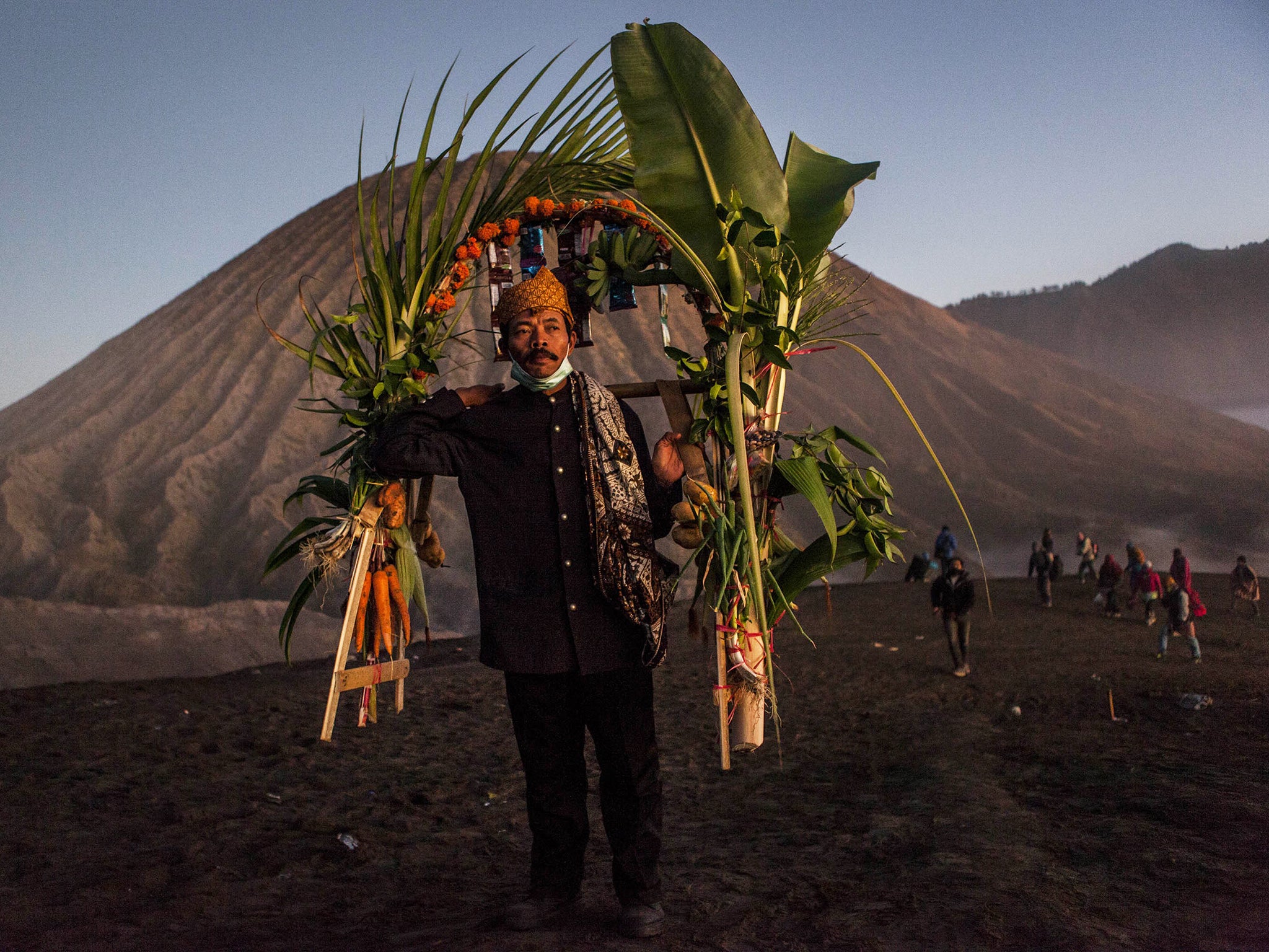 A Tenggerese worshipper carries vegetables for an offerings during the Yadnya Kasada Festival at crater of Mount Bromo in Probolinggo, East Java