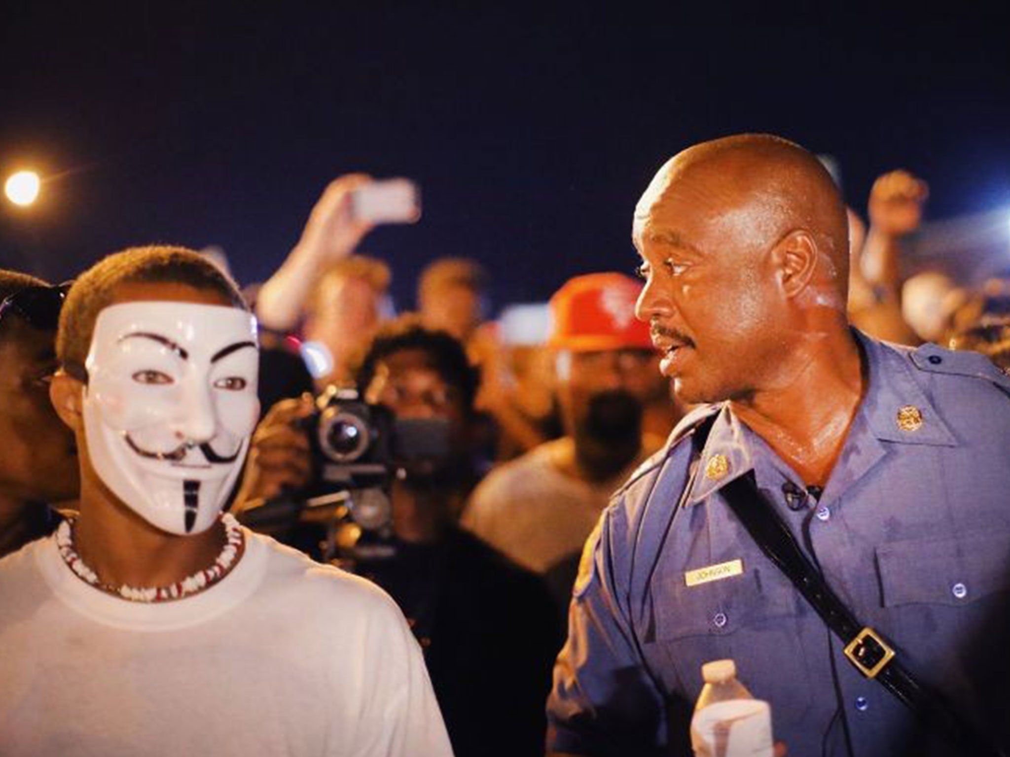 Capt. Ronald Johnson walks among demonstrators last night