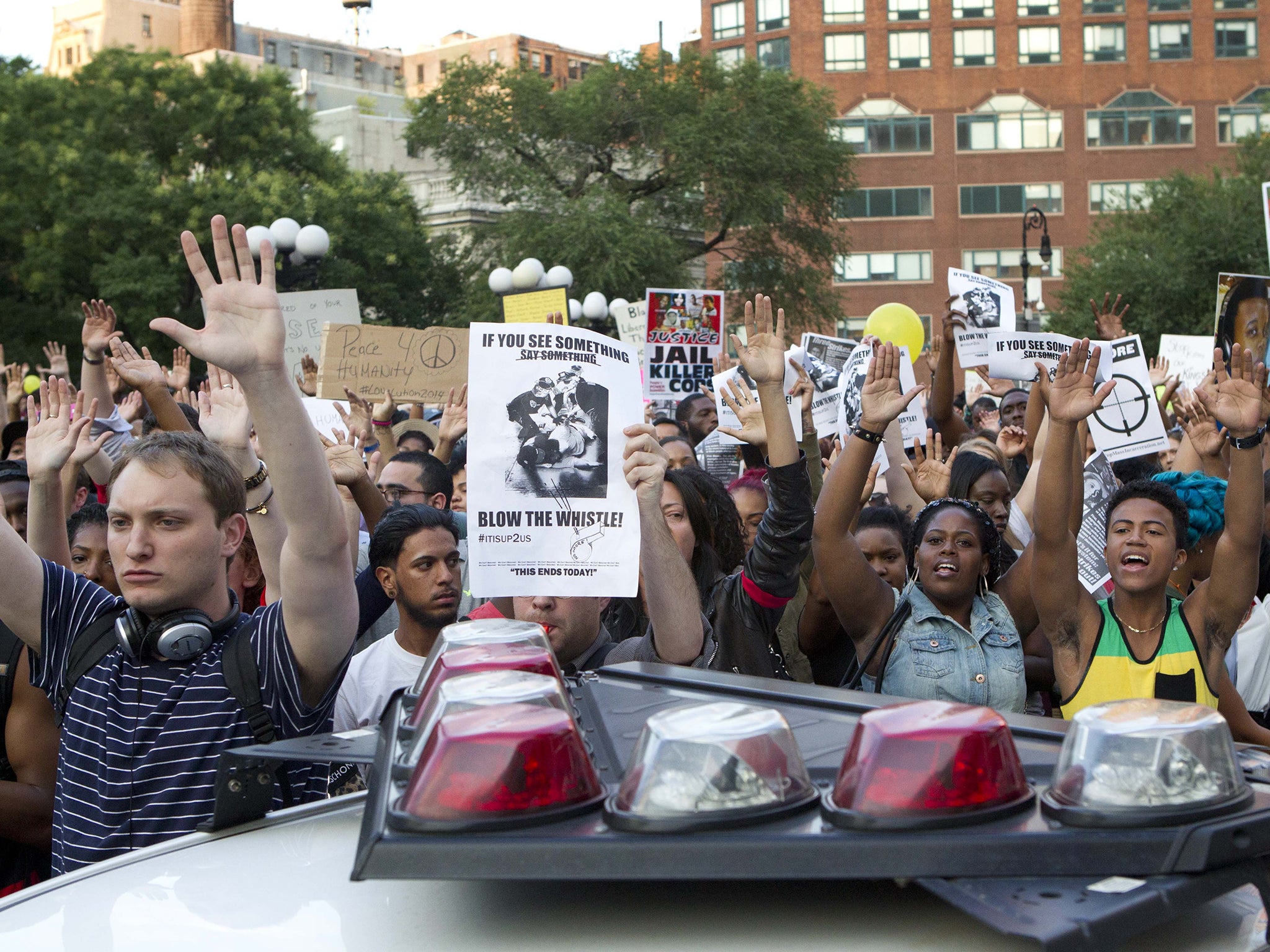 Protesters march in New York City's Union Square. Vigils are being held across the country for people organizers say died at the hands of police brutality