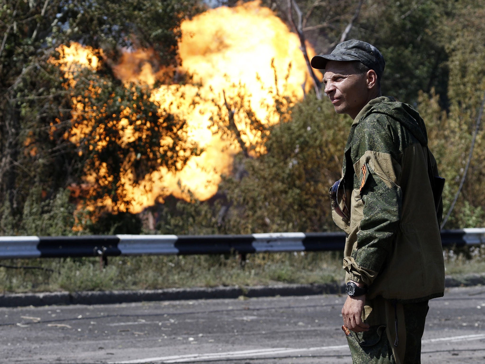 An armed pro-Russian separatist by a shelled gas pipeline in Donetsk yesterday