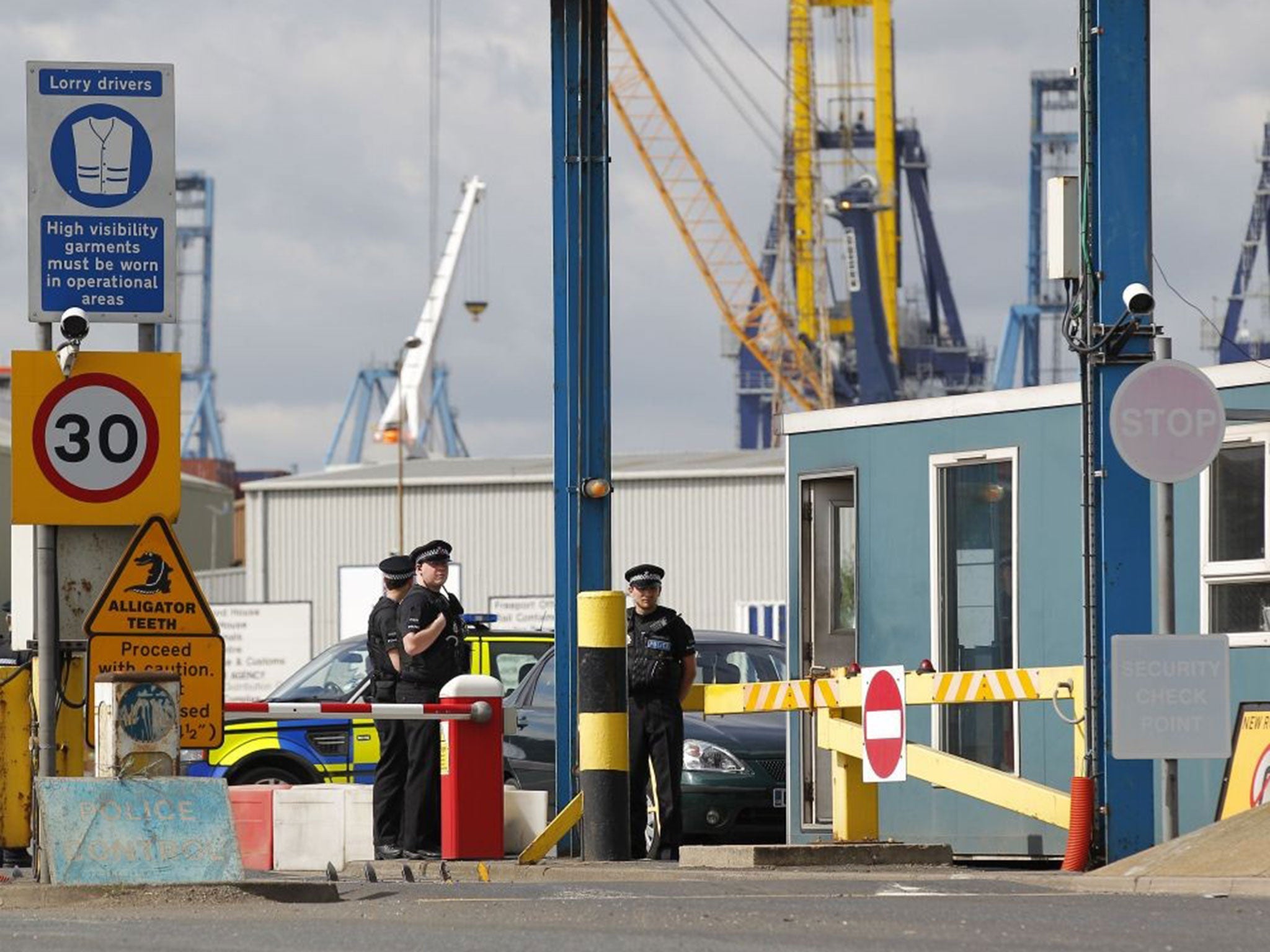 Policemen stand guard at an entrance to Tilbury Docks