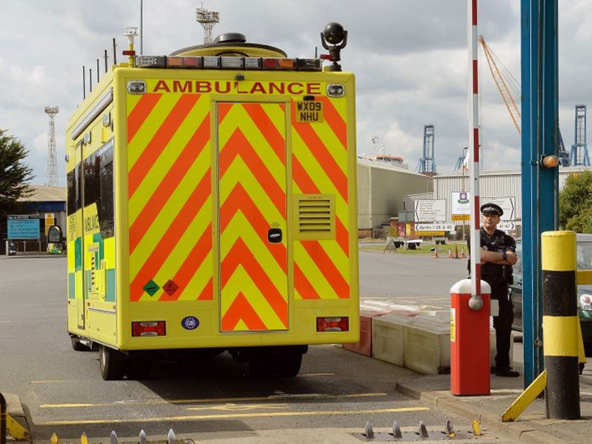 An ambulance incident van passes the main entrance to Tilbury Docks in Essex, where a shipping container was found with illegal immigrants inside