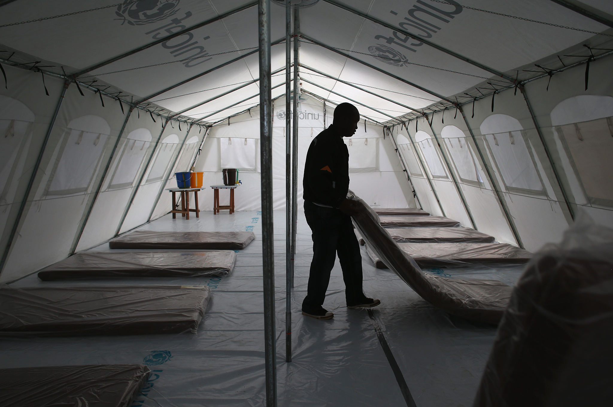 Workers prepare the new Doctors Without Borders (MSF), Ebola treatment center near Monrovia, Liberia.