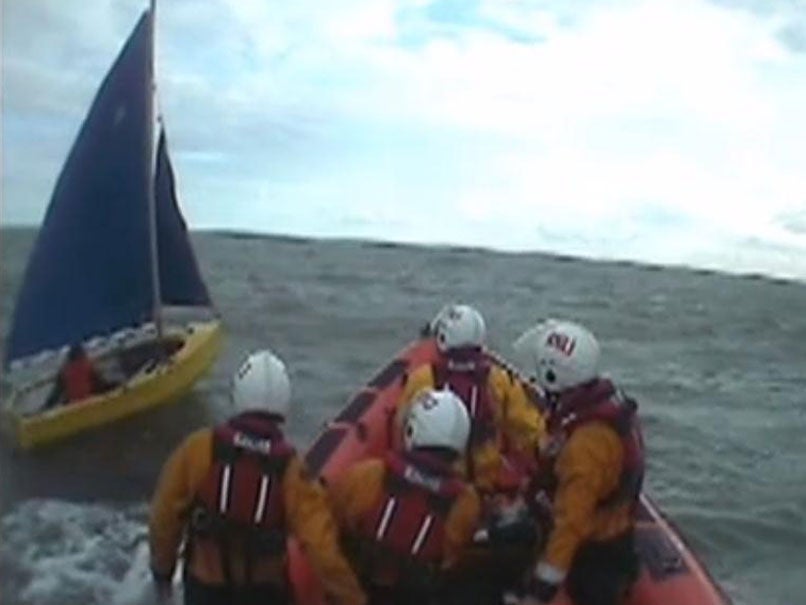 The RNLI pulling alongside the dinghy off the Dorset coast