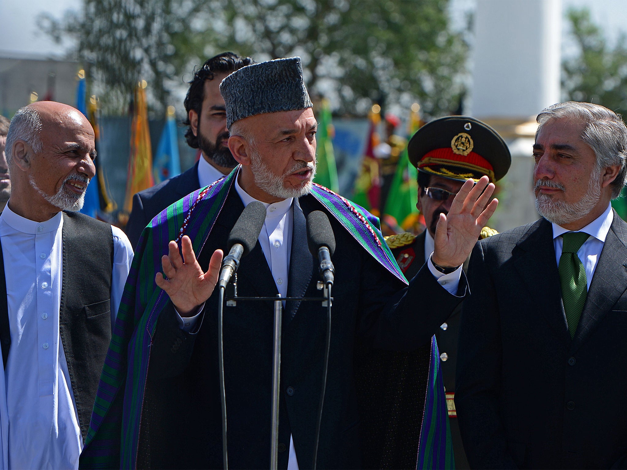 Hamid Karzai (centre) has agreed to step down as Ashraf Ghani
(left) and Abdullah Abdullah (right) fight to succeed him