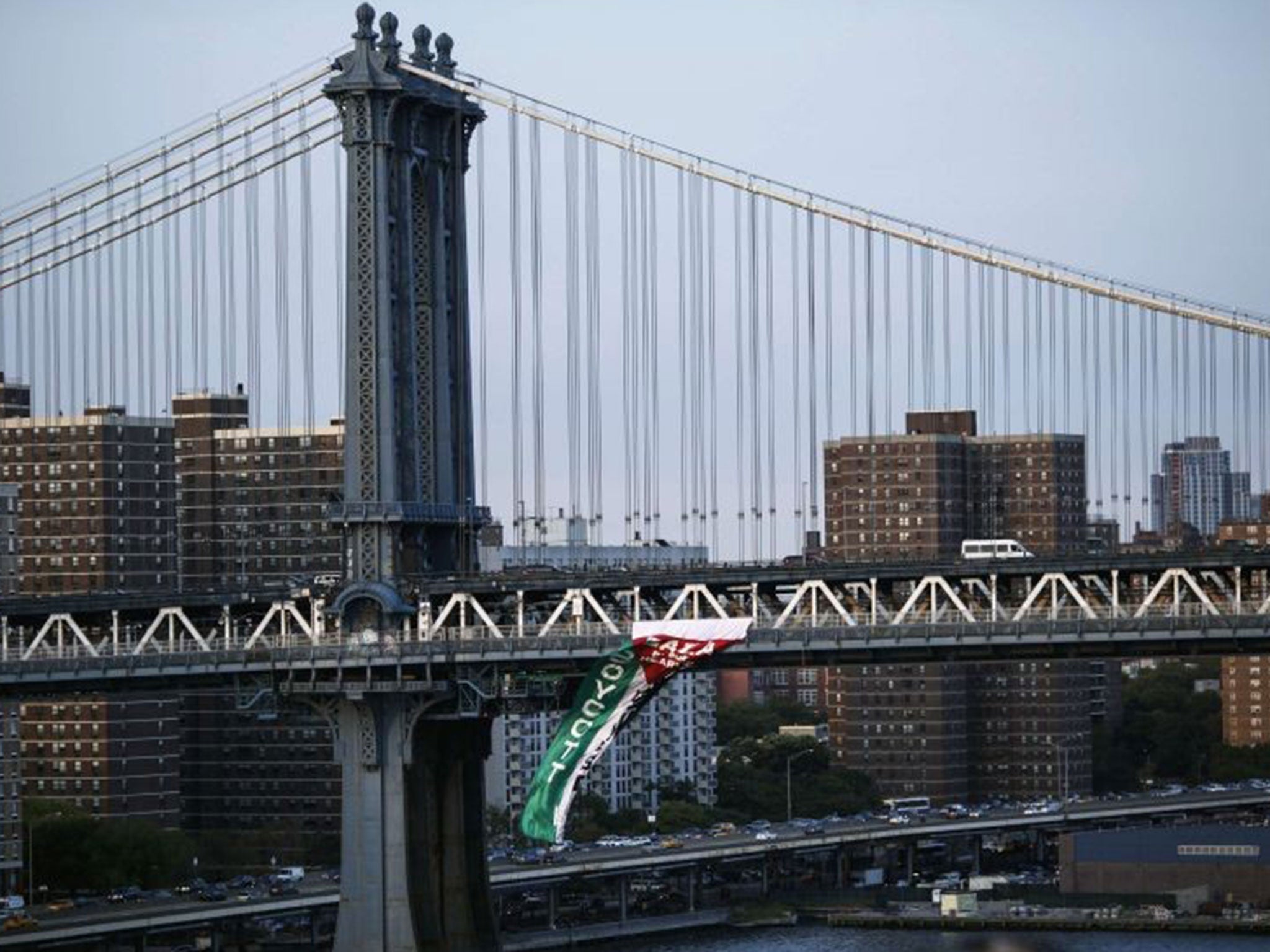 A pro-Palestinian flag is seen hanging from the Manhattan Bridge