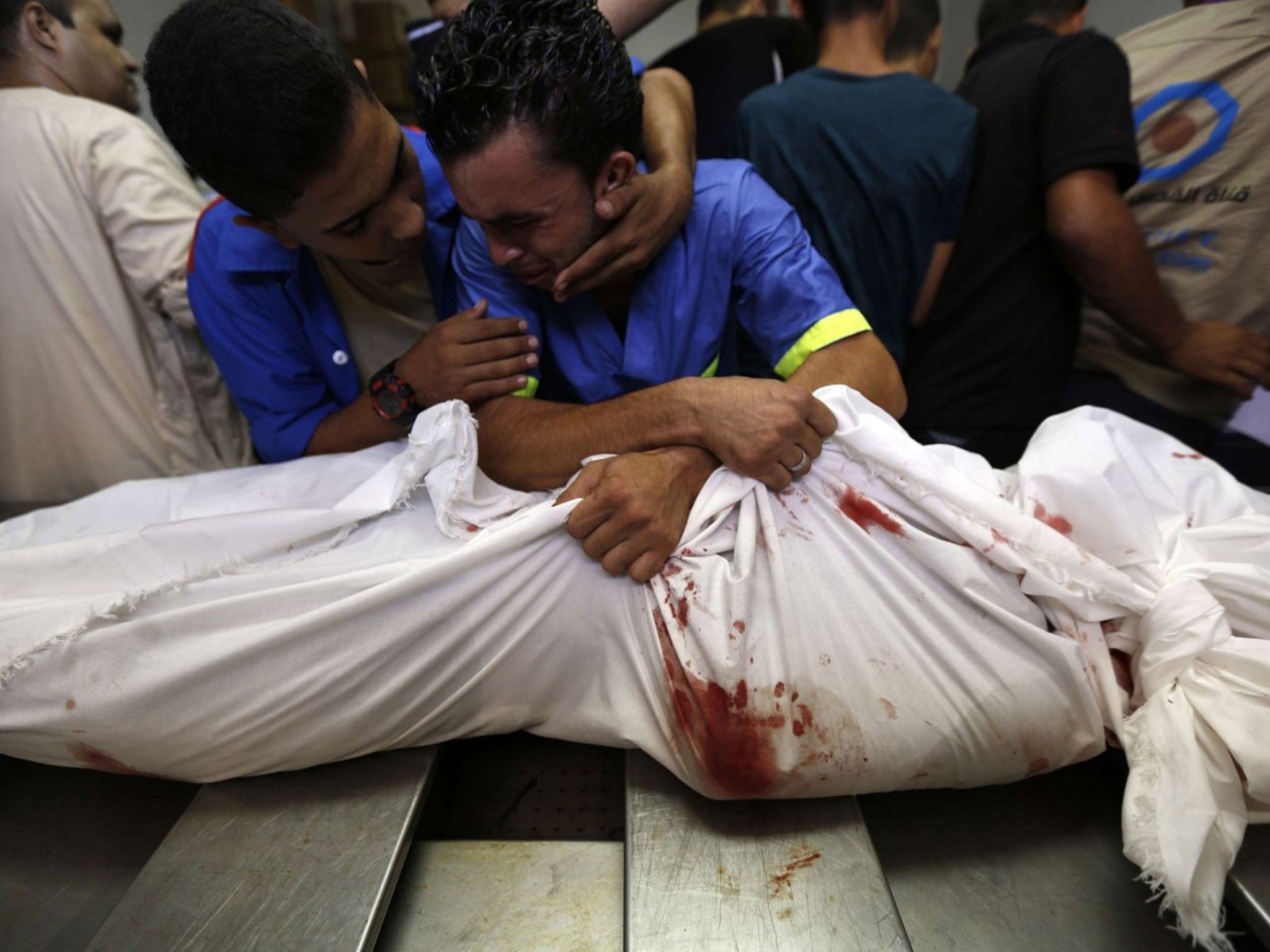 A Palestinian man mourns over the body of his relative, Rami Abu Nahel, killed in an Israeli military strike