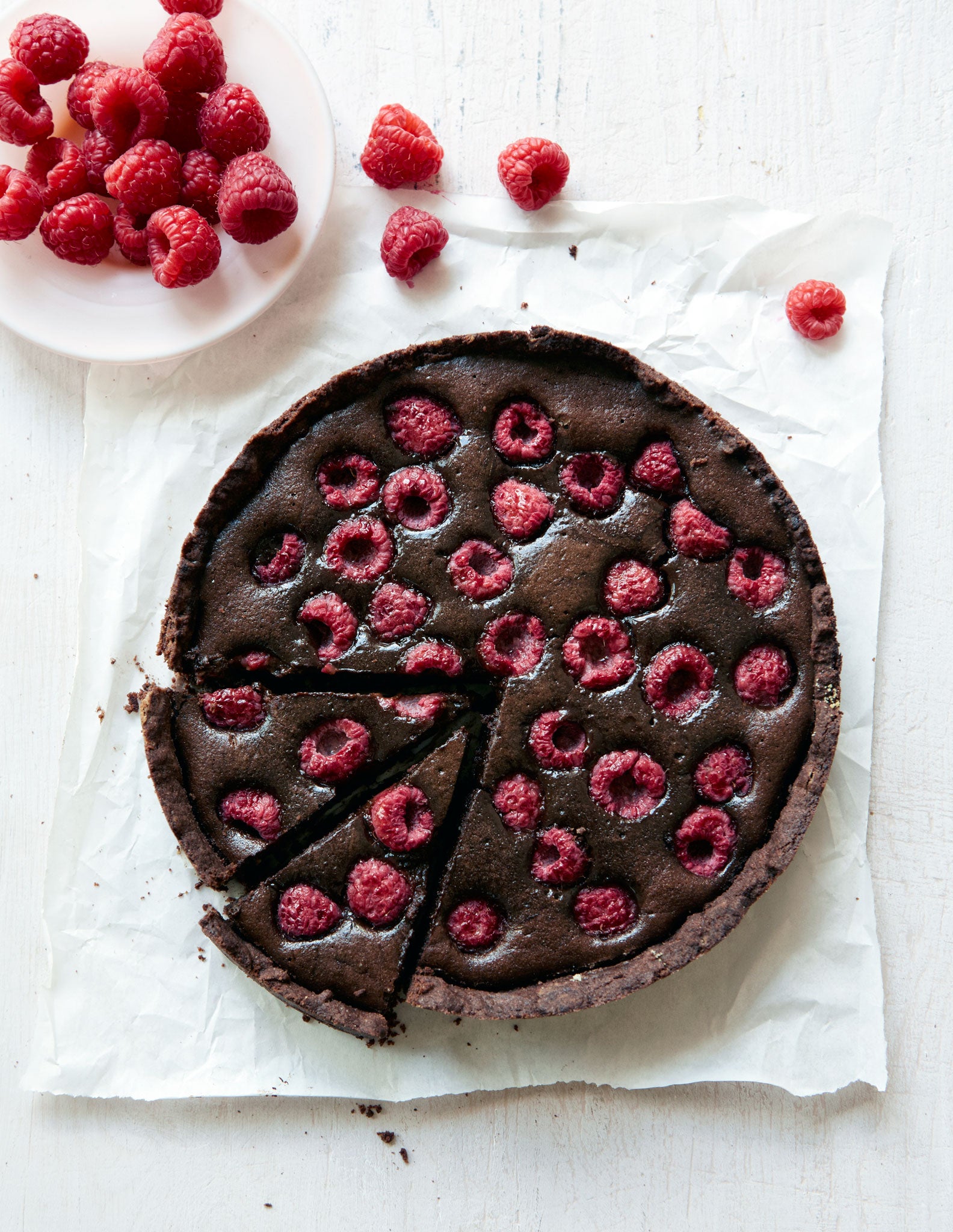 Serve Bill's chocolate and raspberry tart with extra fresh raspberries to contrast with the gooey ones inside