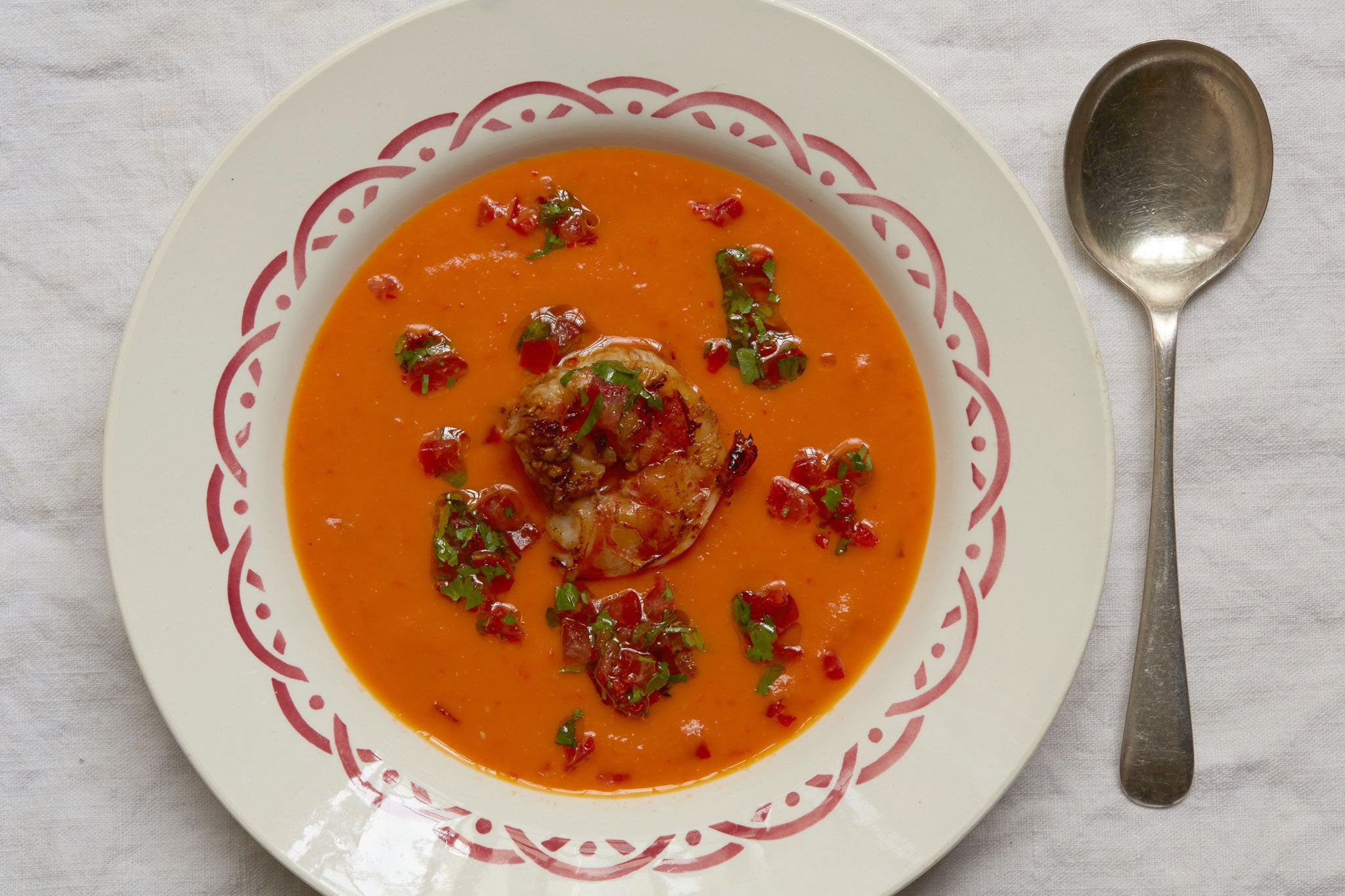 Place the prawns in the centre and spoon the tomato mixture around them