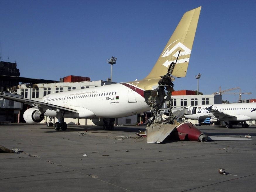 A damaged aircraft is pictured after shelling at Tripoli International Airport August 24, 2014