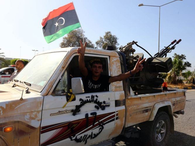 Islamist fighters in the Fajr Libya (Libyan Dawn) coalition arrive at the entrance of Tripoli international airport on August 24, 2014