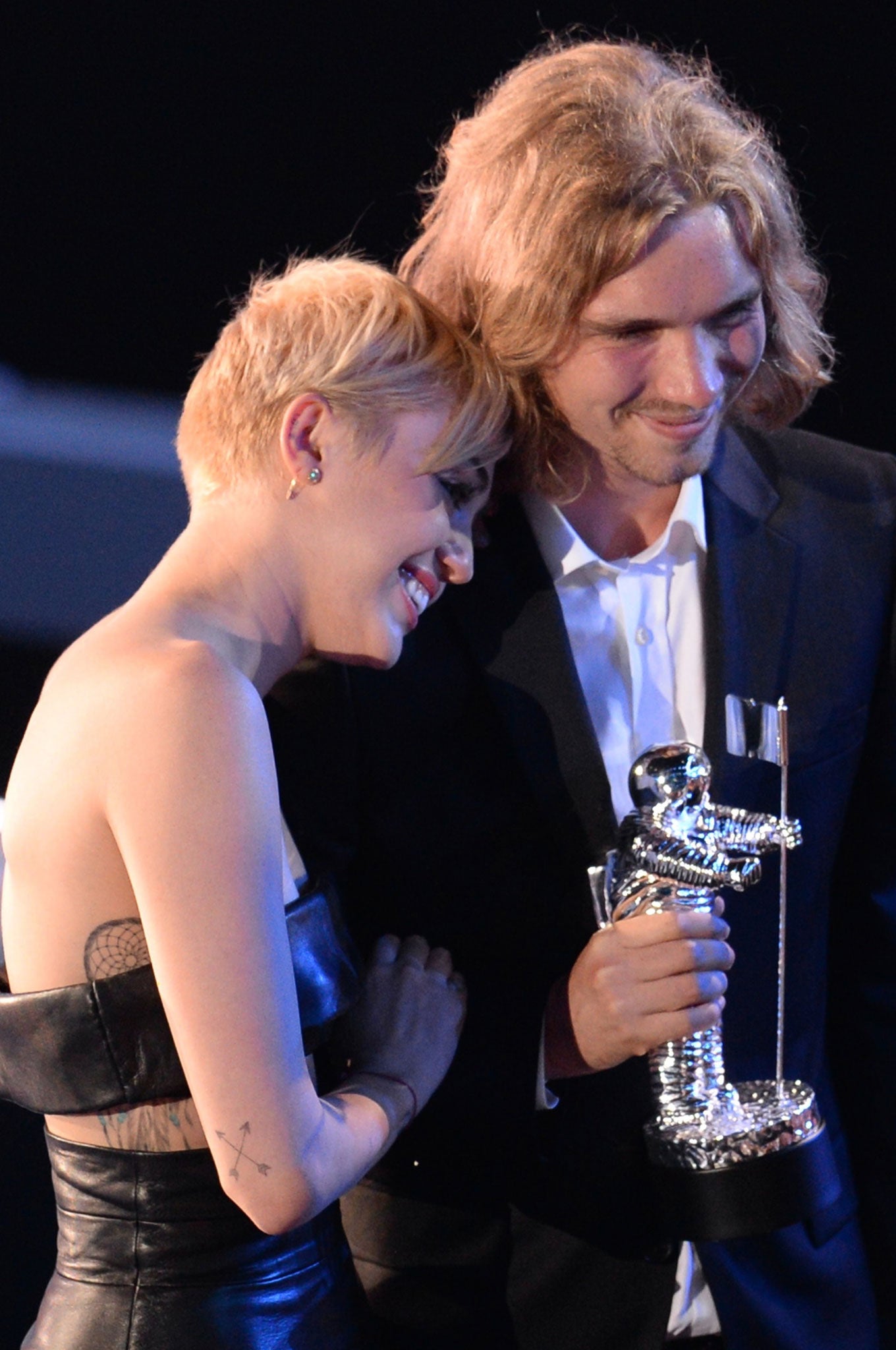 My Friend's Place representative Jesse (right) accepts Video of the Year with singer Miley Cyrus for 'Wrecking Ball' on stage at the MTV Video Music Awards (VMA) at The Forum in Inglewood, California