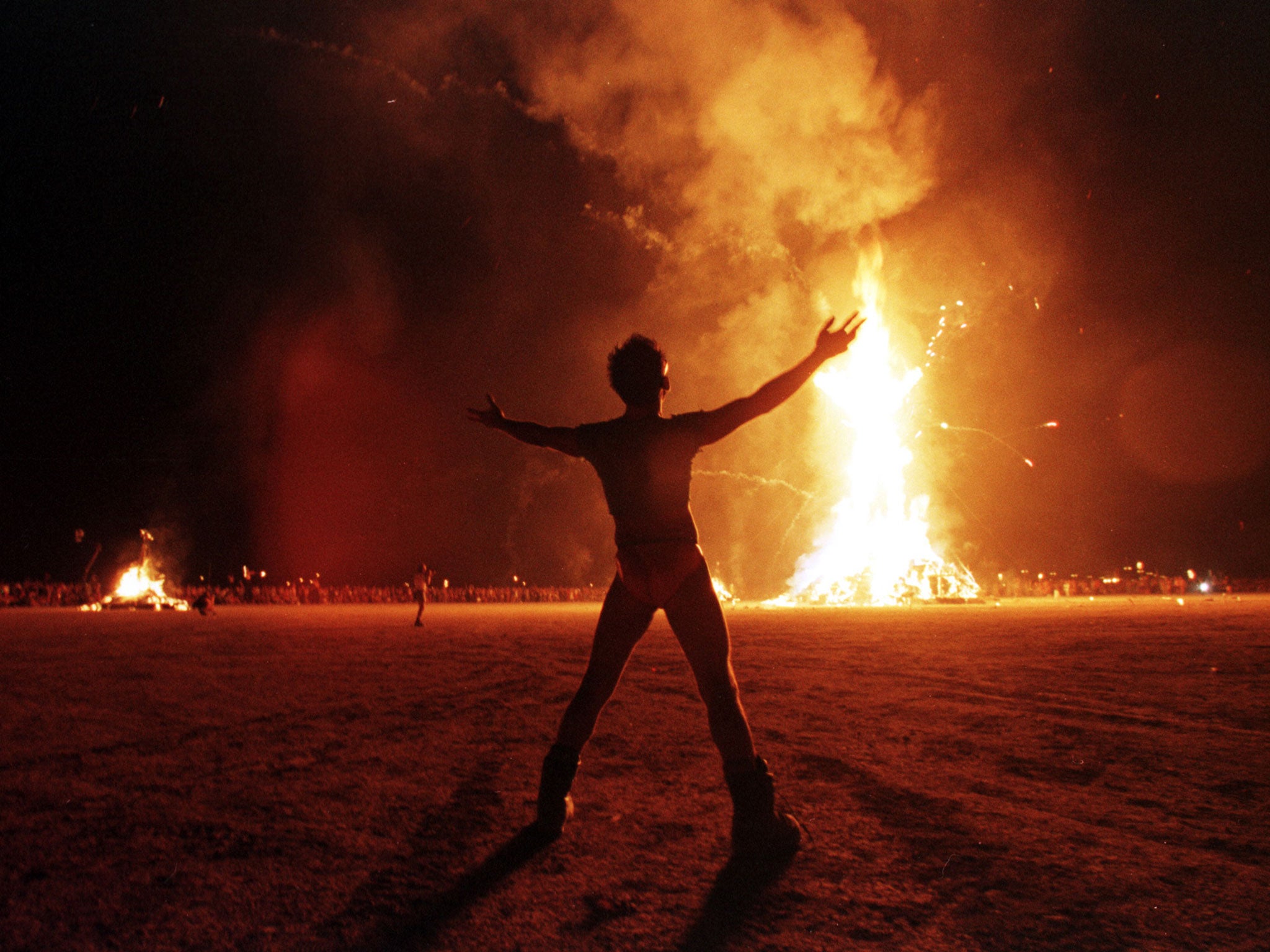 A festival-goer celebrates the end of last year'sBurning Man festival in Nevada