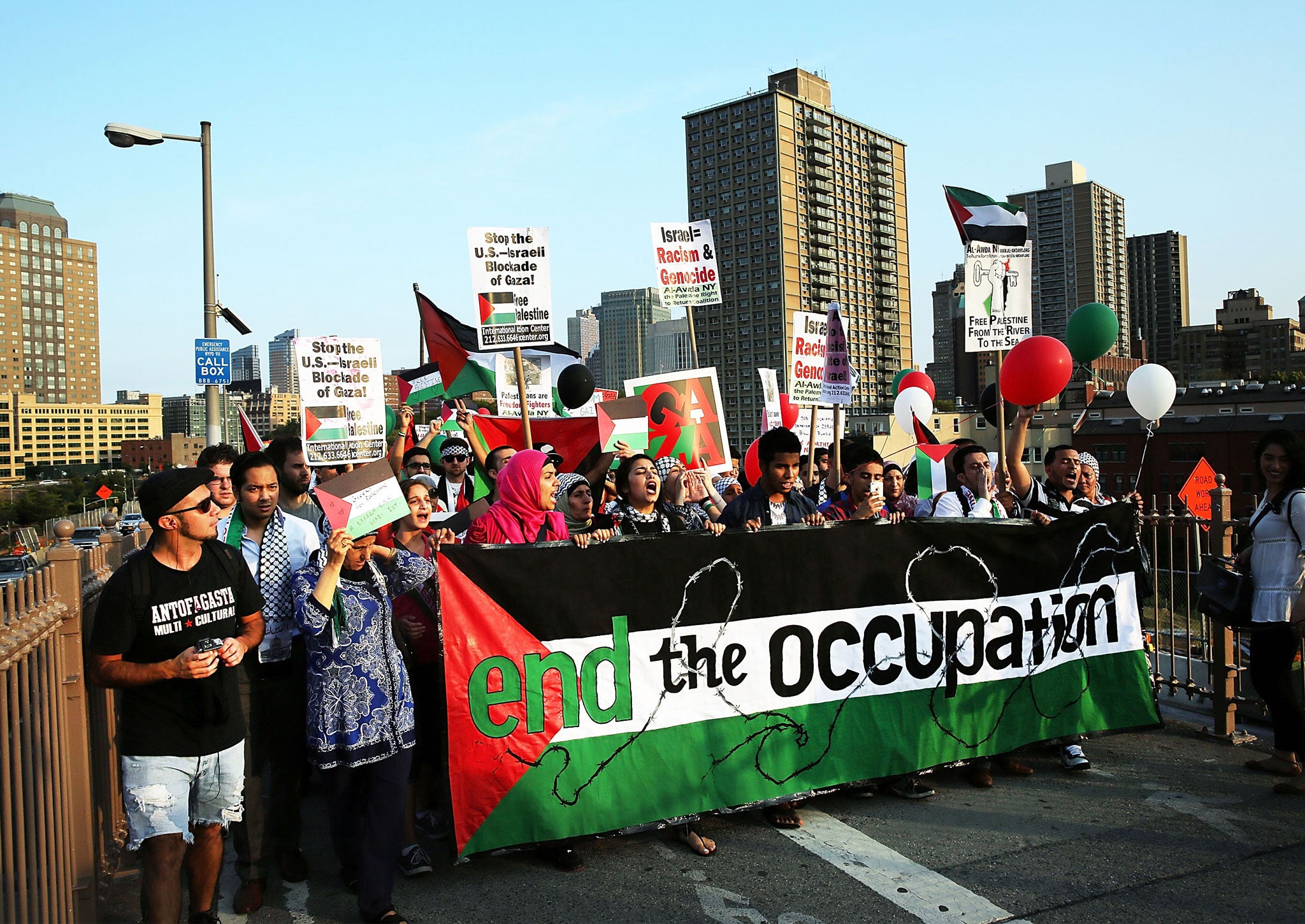 Demonstrators walk across the Brooklyn Bridge while protesting against Israel's continued military campaign in Gaza on August 20, 2014 in New York City.