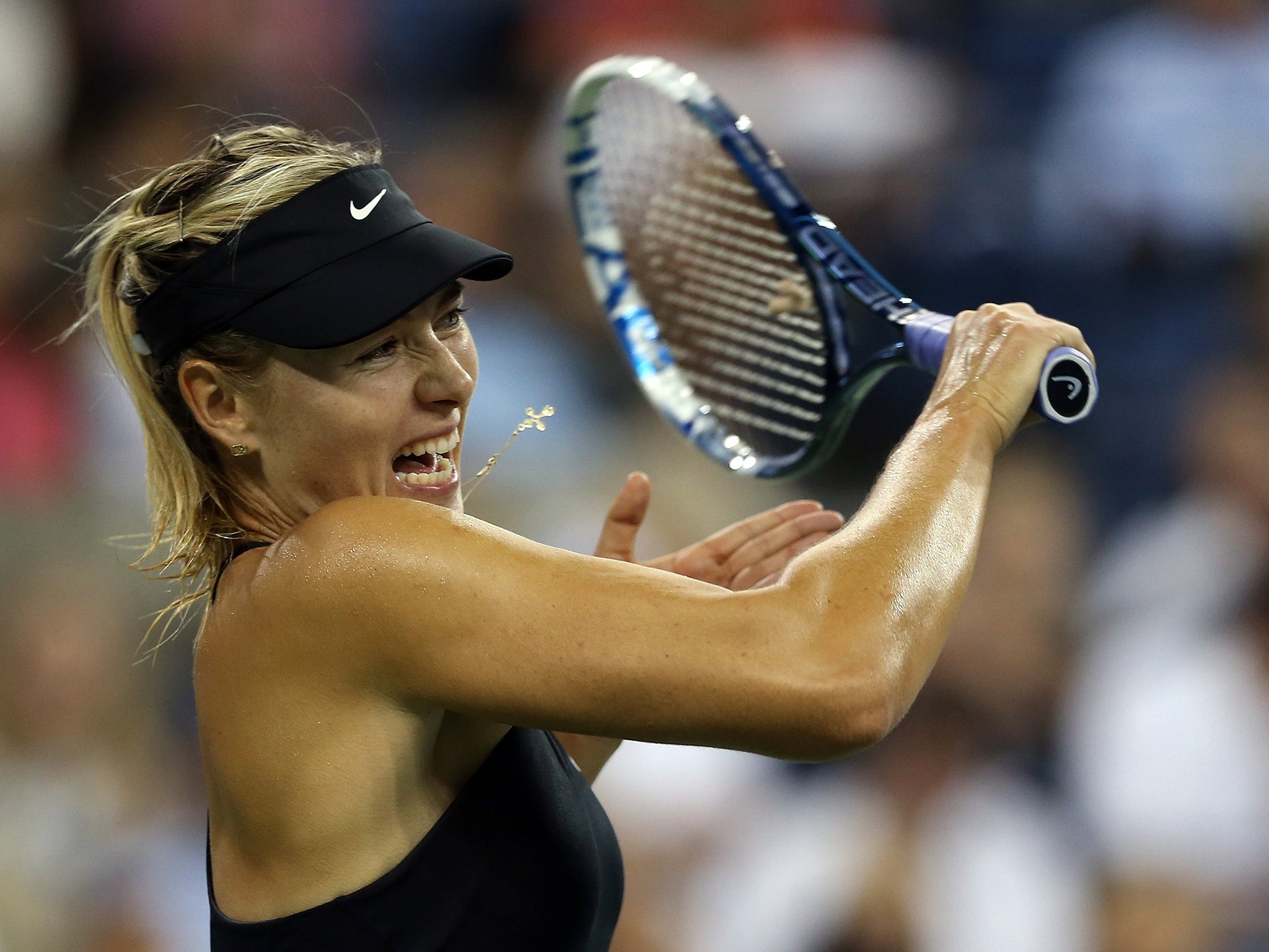 Maria Sharapova of Russia returns a shot against Maria Kirilenko at the US Open
