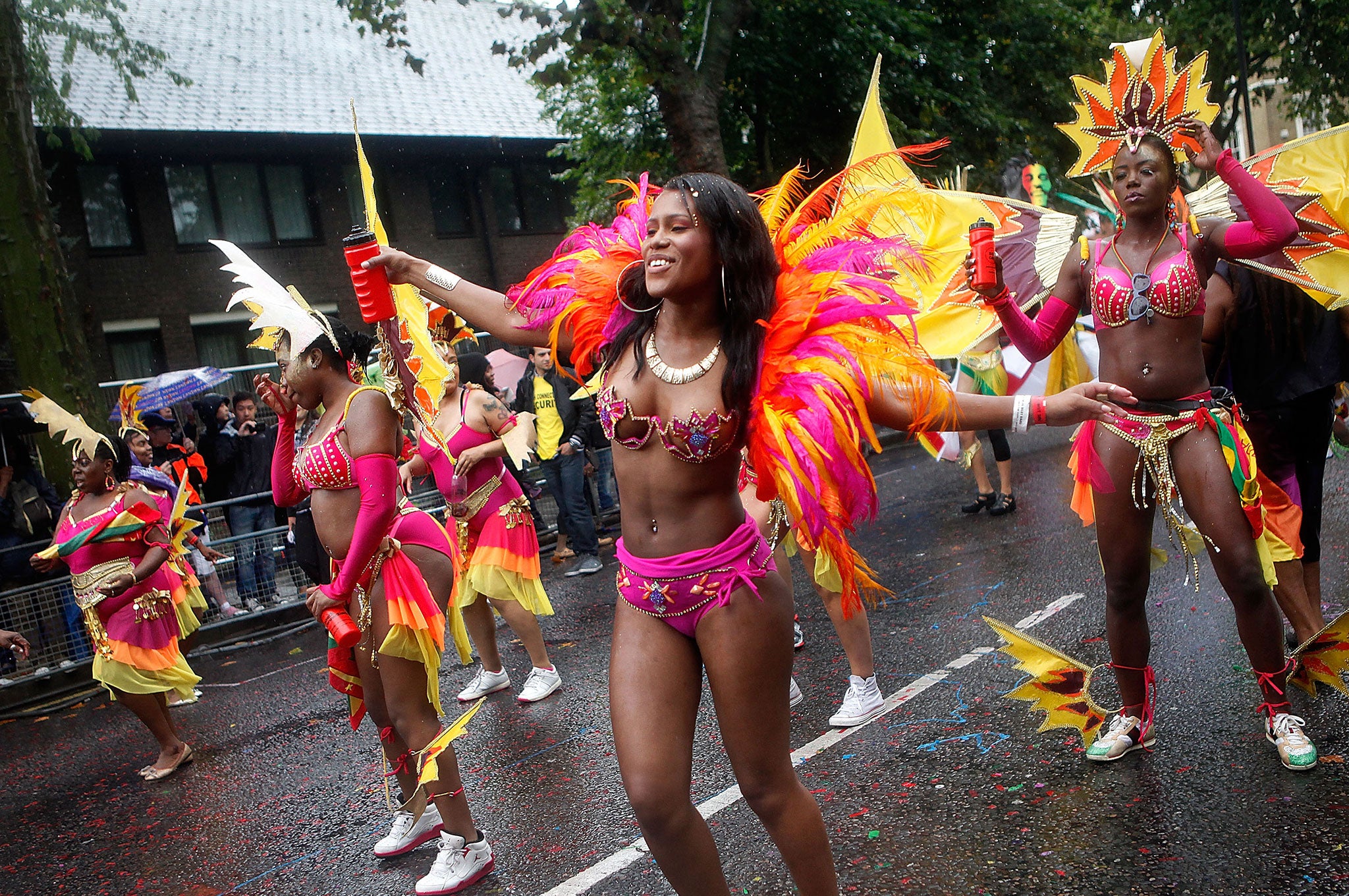 Performers dance through heavy rain during the Notting Hill Carnival in London.