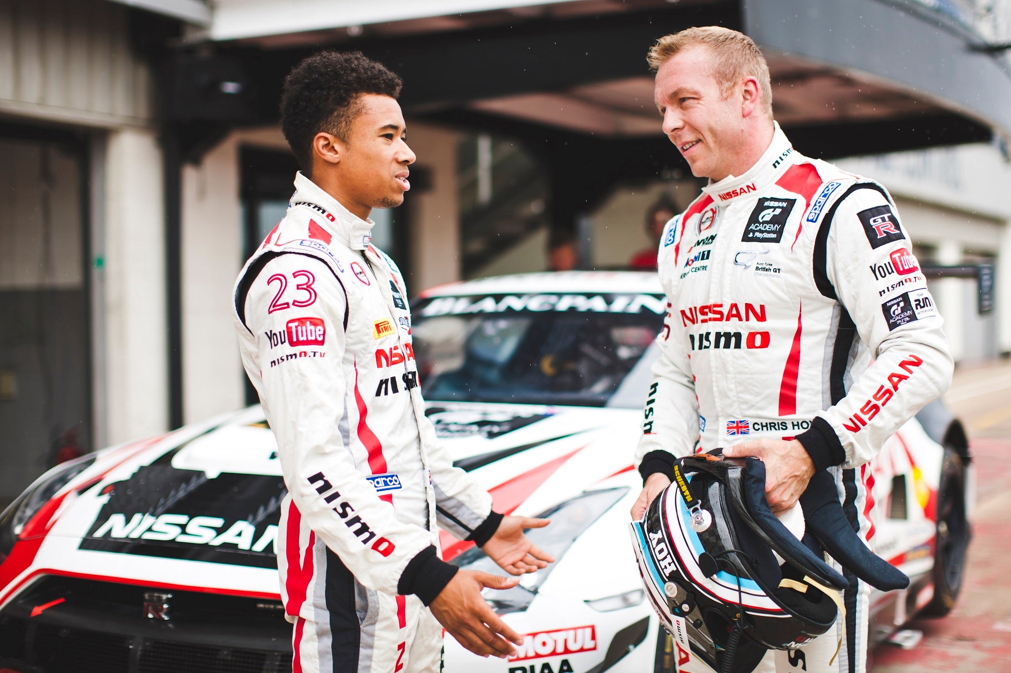 Jann Mardenborough (L) and Sir Chris Hoy (R) discuss tactics in front of the NISMo GT-R GT3 they will drive at Brands Hatch this weekend