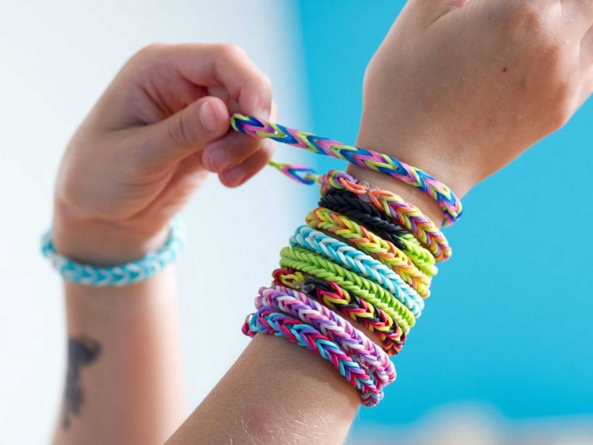 A girl shows off her loom band designs