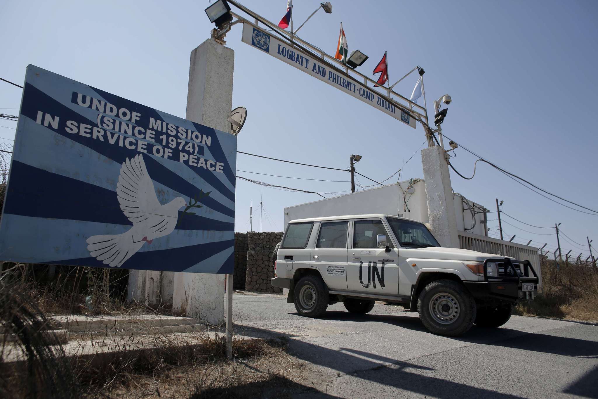 A car leaves the main UN headquarters next to the Quneitra crossing, the only border crossing between Israel and Syria