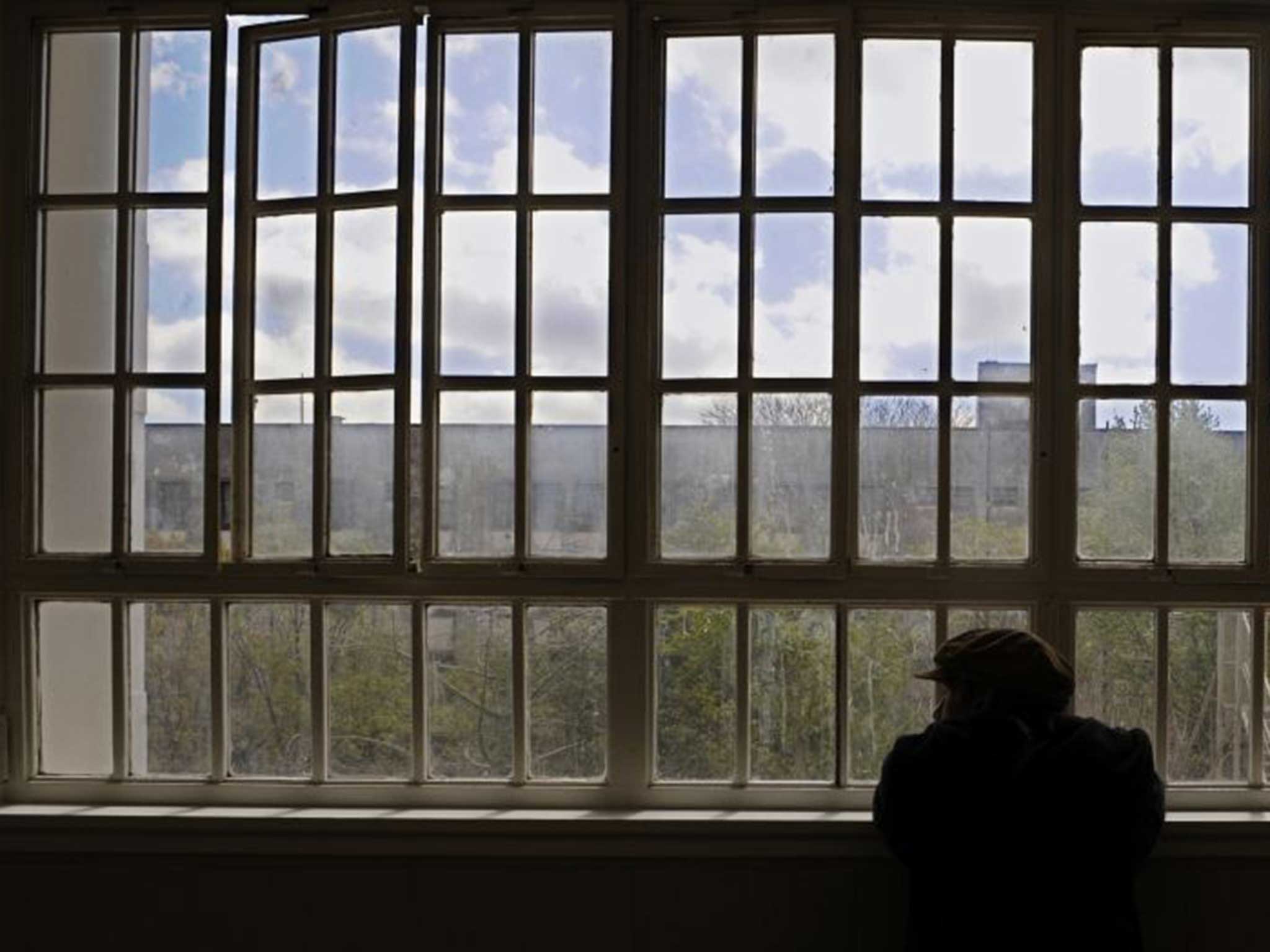 An inmate of the Borda neuropsychiatric hospital looks through windows in the ward