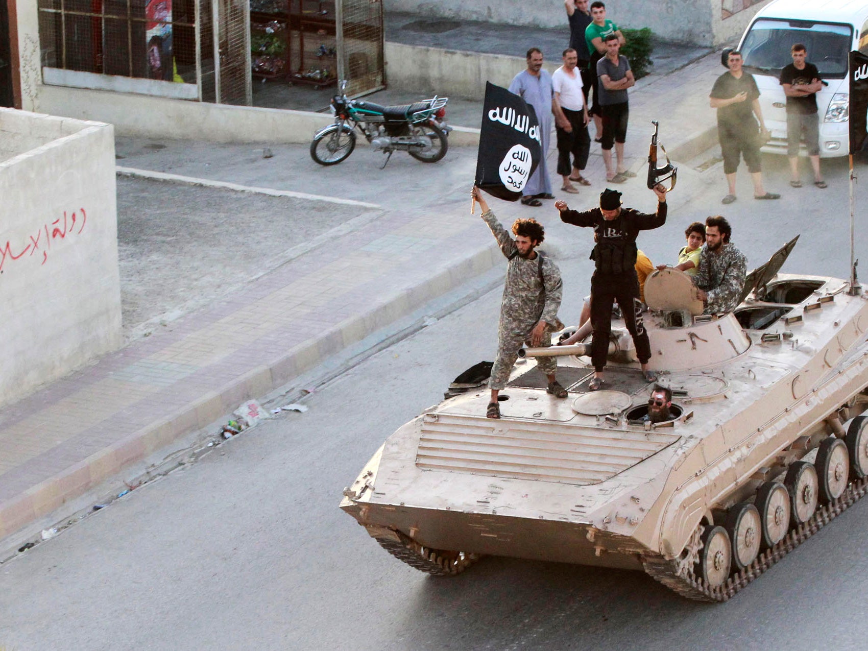 Militant Islamist fighters take part in a military parade along the streets of northern Raqqa province June 30, 2014. Militant Islamist fighters held a parade in Syria's northern Raqqa province to celebrate their declaration of an Islamic "caliphate" afte