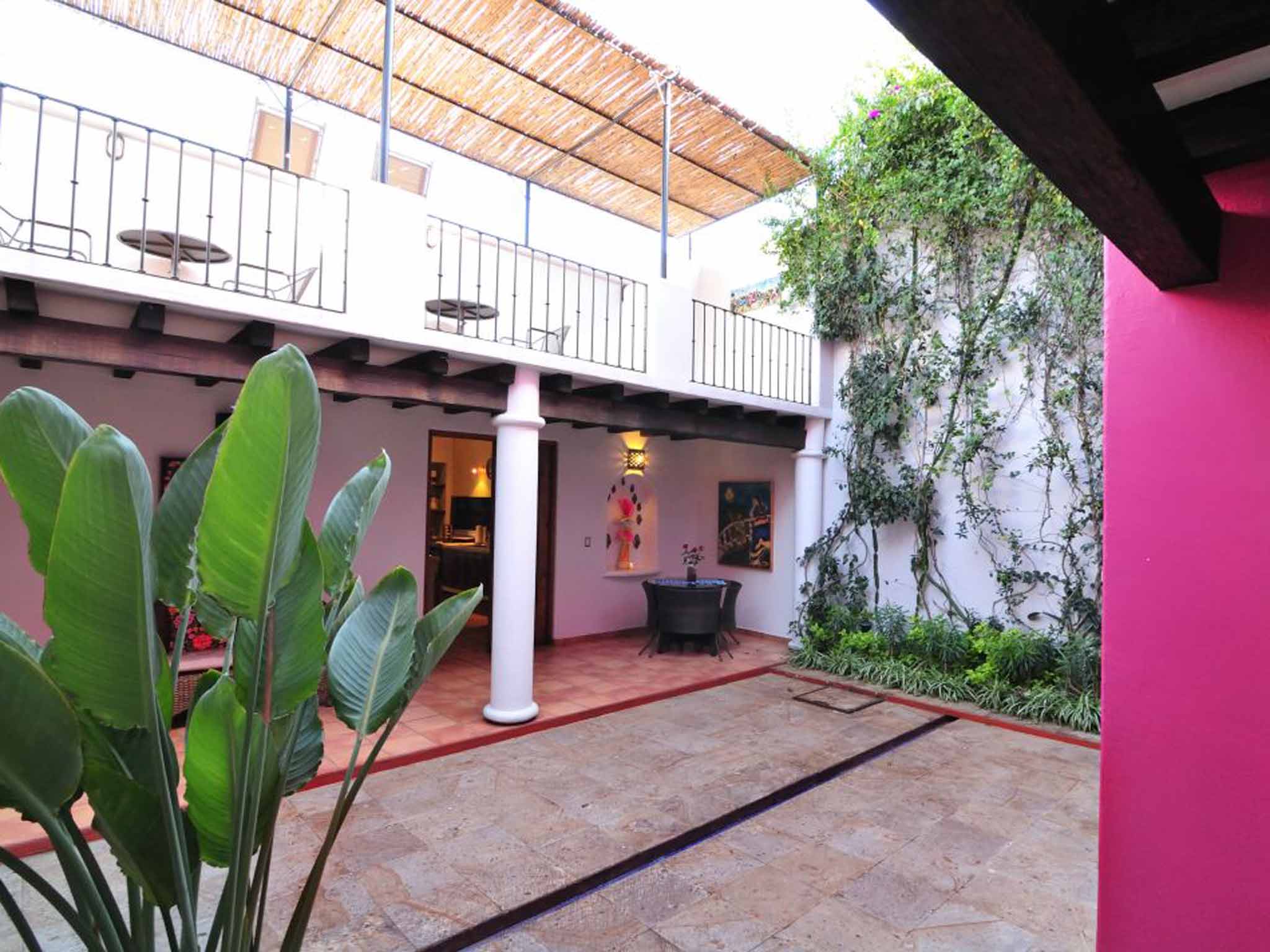 Tropical tastes: Bright colours and cool corners define the casa's central courtyard and kitchen