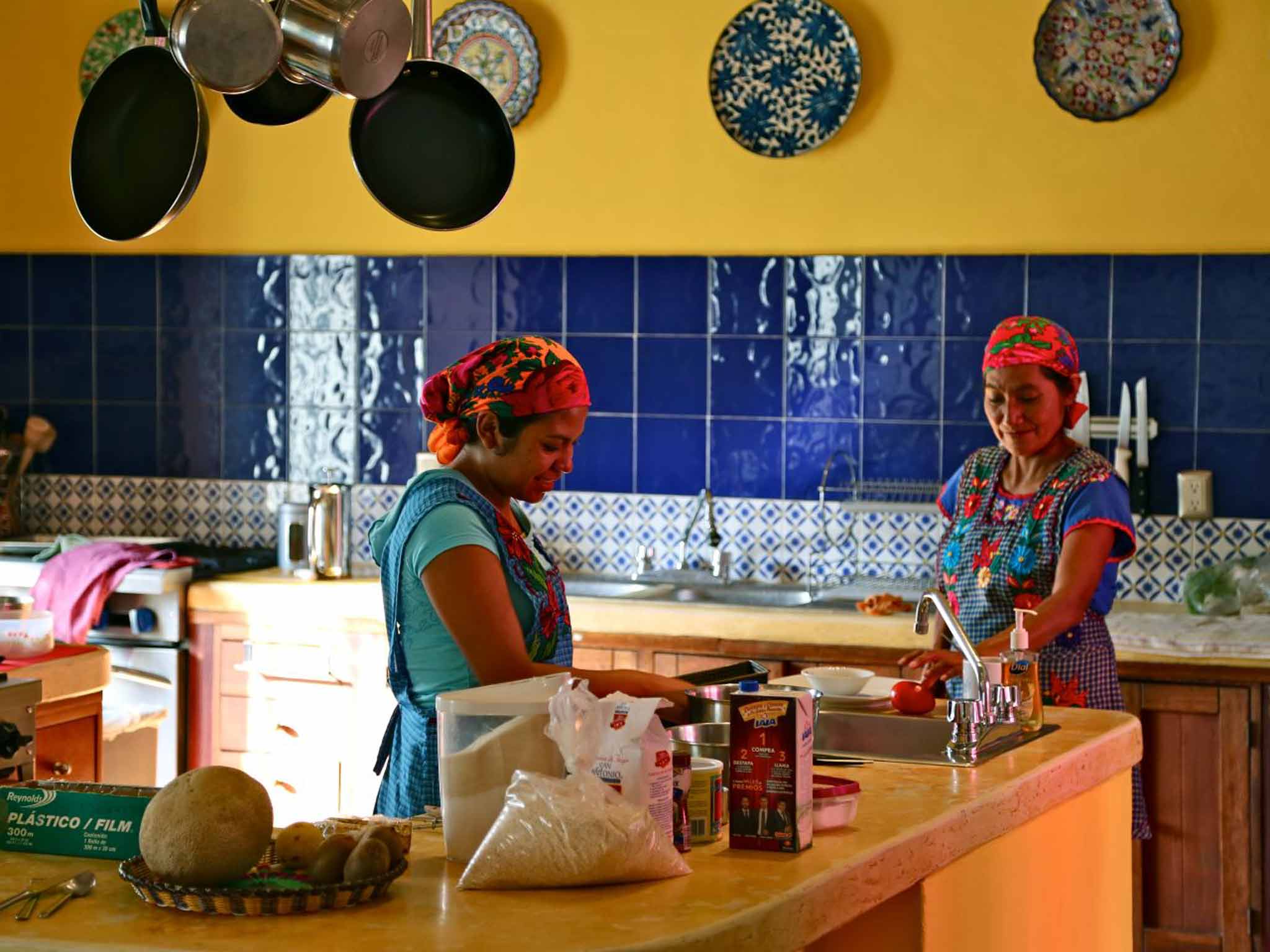 Bright colours and cool corners define the casa's central courtyard and kitchen