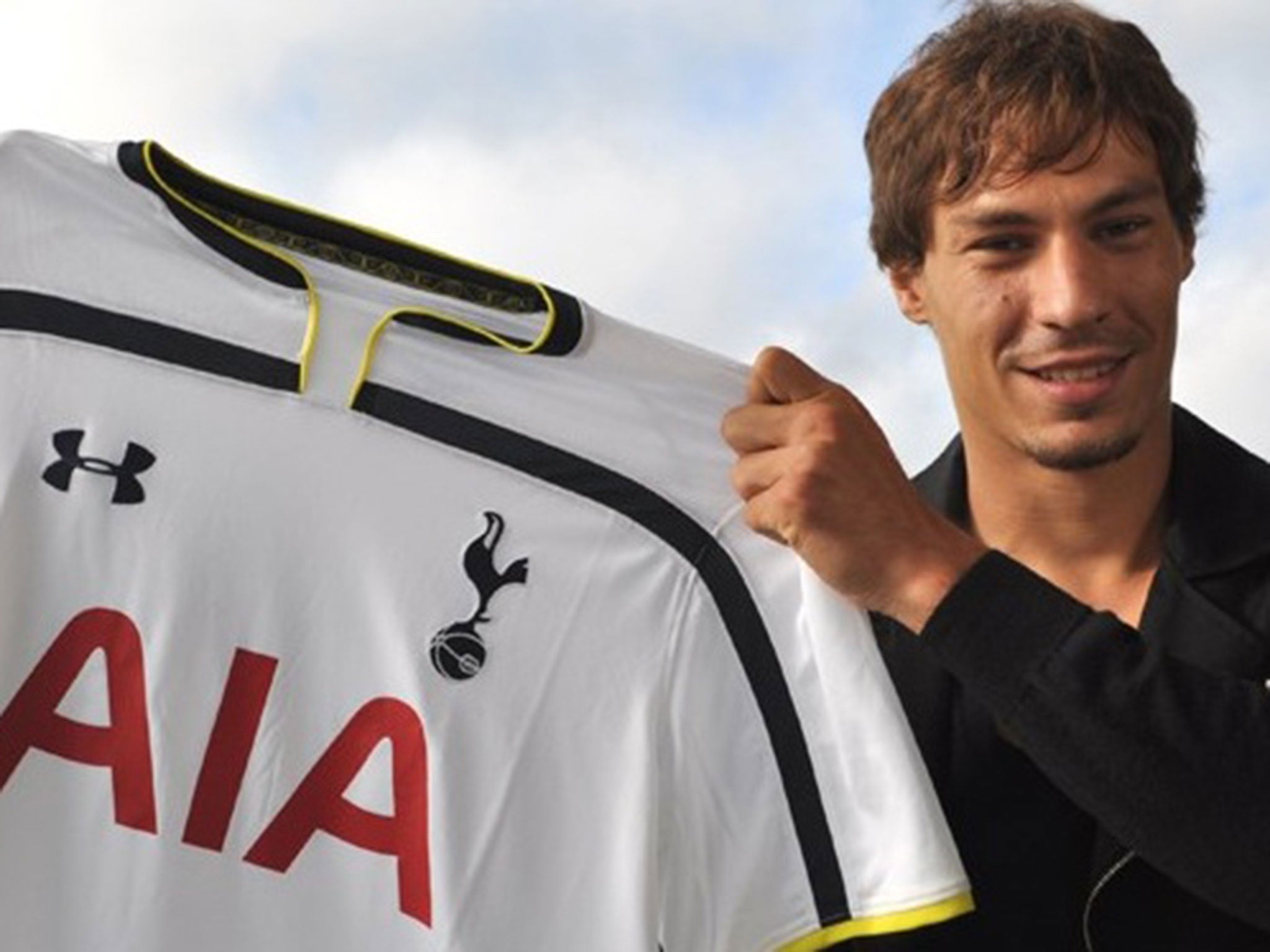 Benjamin Stambouli holds up his Tottenham shirt