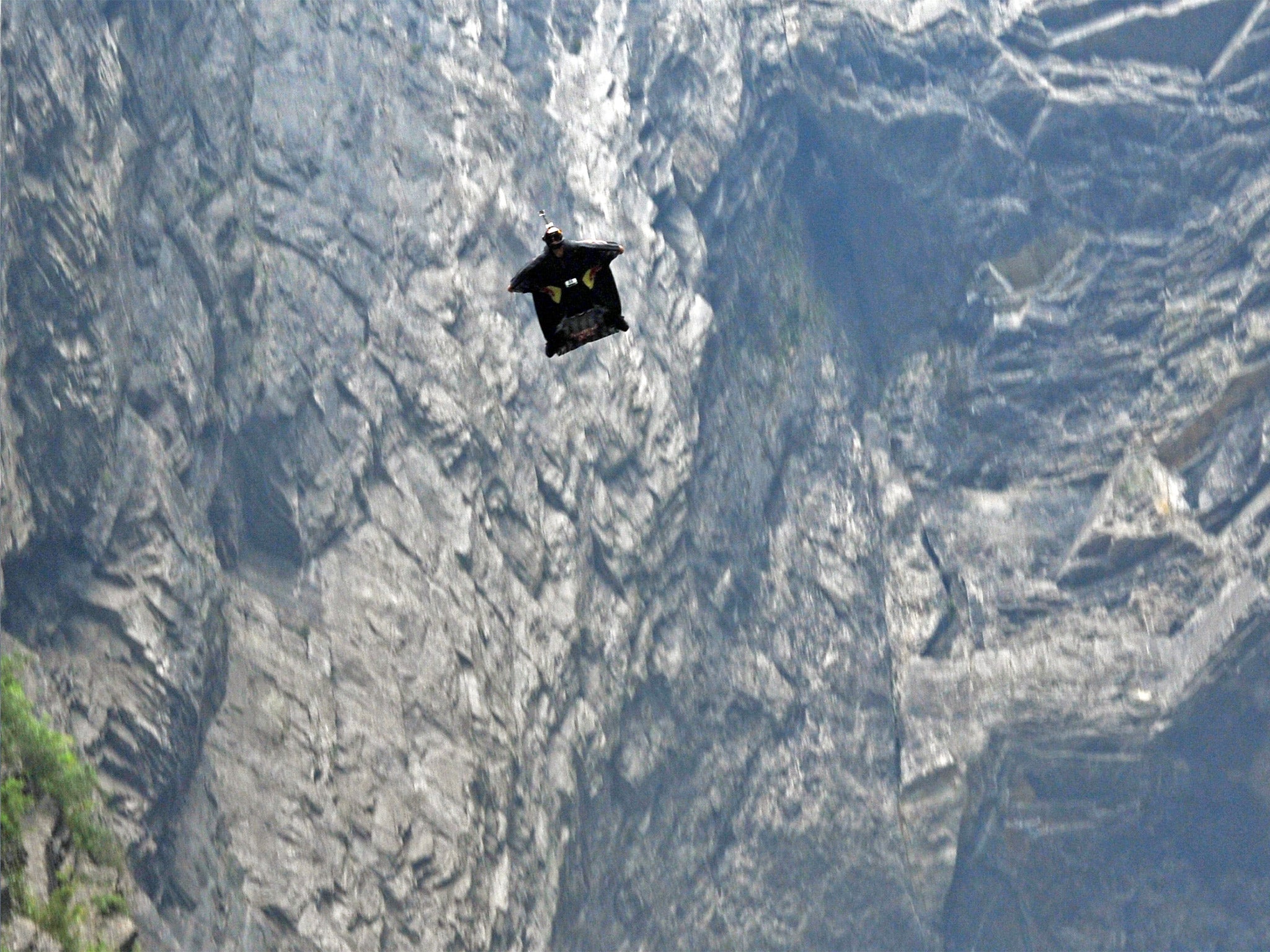 Jeb Corliss gliding through the Tianmen Cave, China, having jumped out of a helicopter at 6,000 feet, in 2011