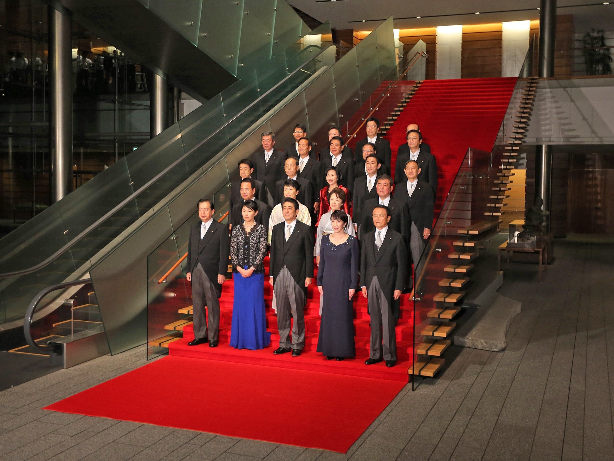 Prime Minister Shinzo Abe (centre, front) poses with members of his new cabinet, which includes five women, following their first meeting at his official residence in Tokyo