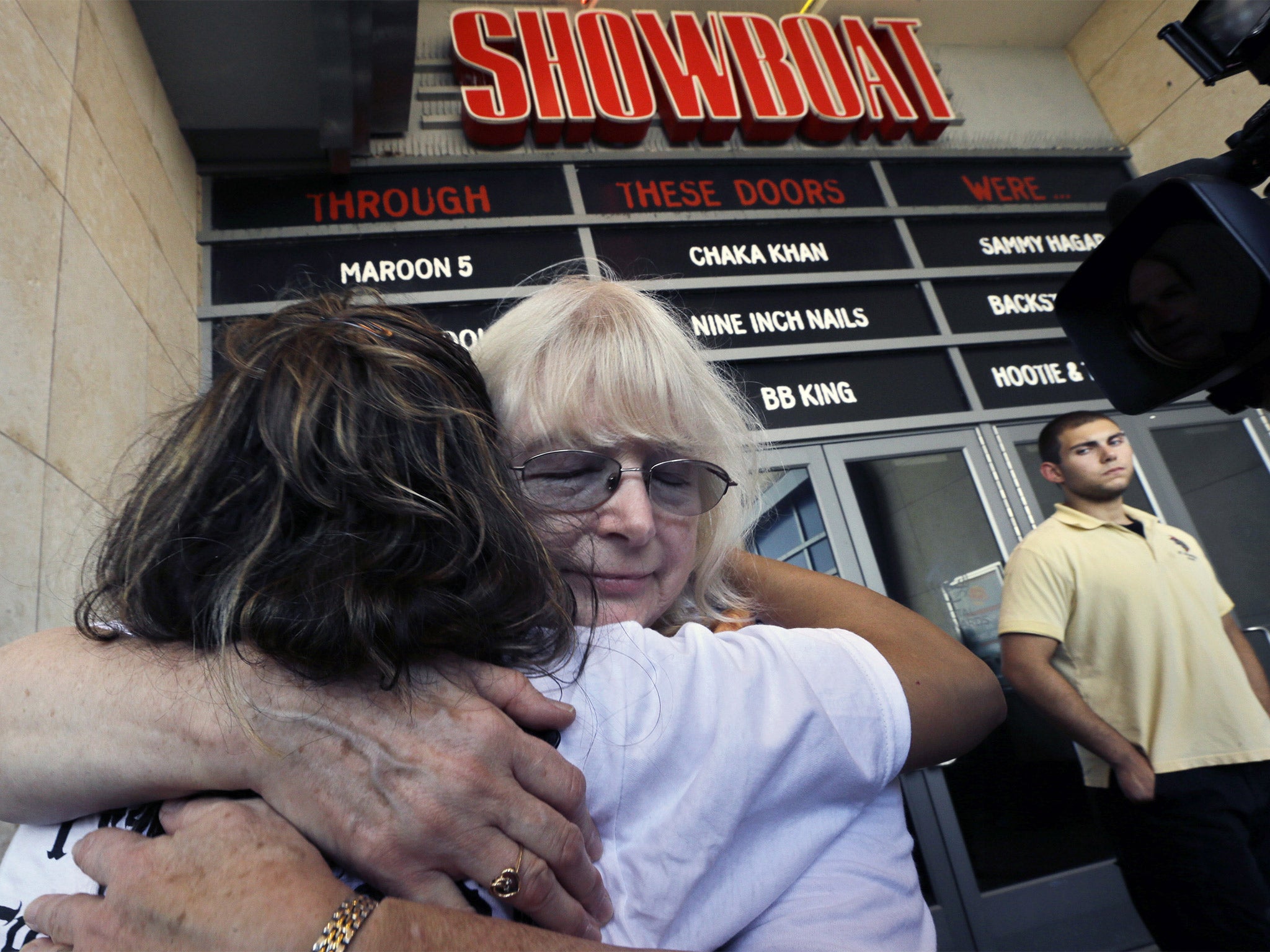 Long time employees hug as they leave the closing Showboat Casino Hotel, which shut down after 27 years on the Boardwalk