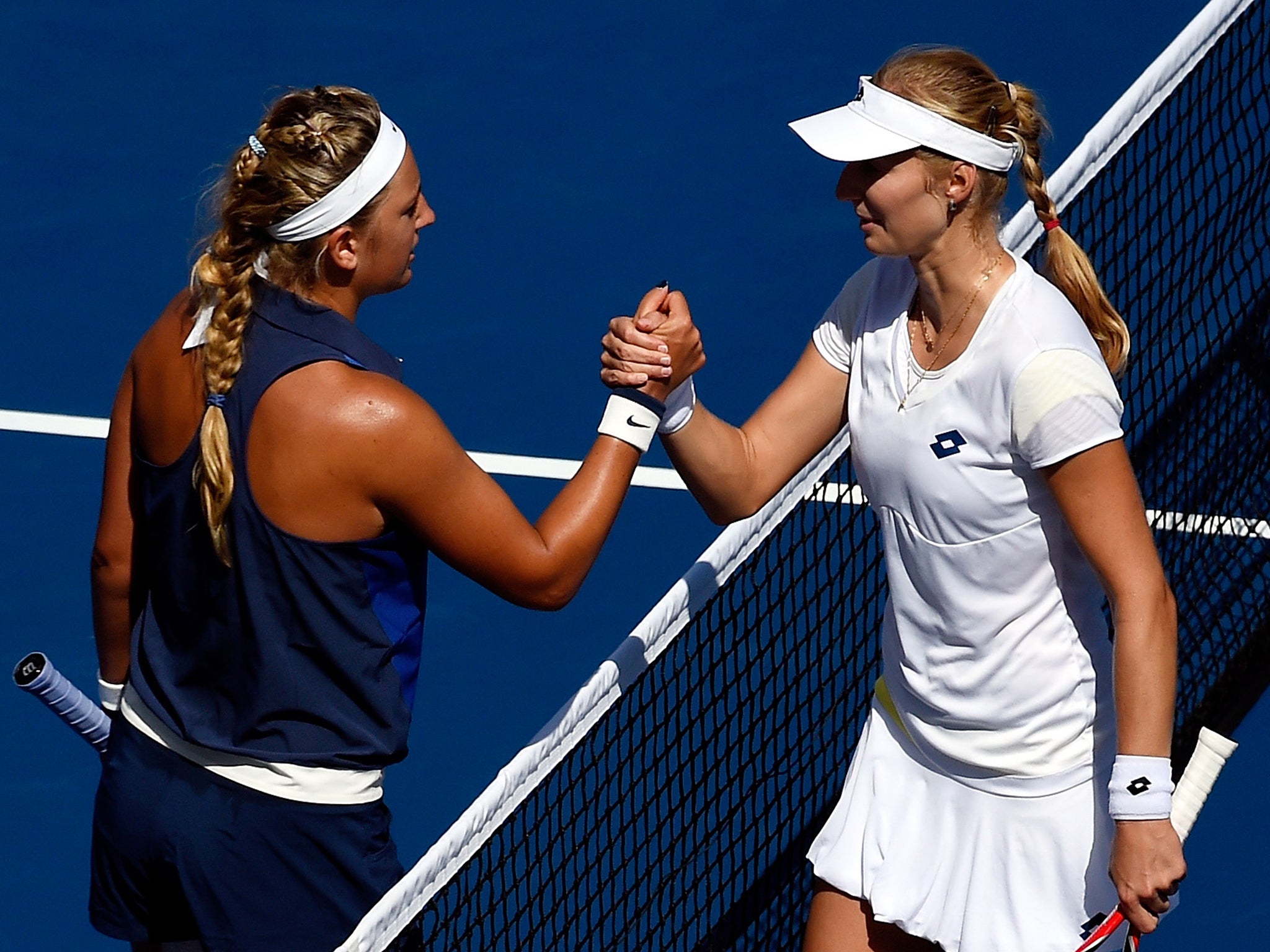 Ekaterina Makarova (R) of Russia shakes hands Victoria Azarenka (L) of Belarus after their women's singles quarter-final match