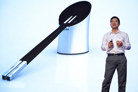 Baidu CEO Robin Li unveiling the smart chopsticks in Beijing.