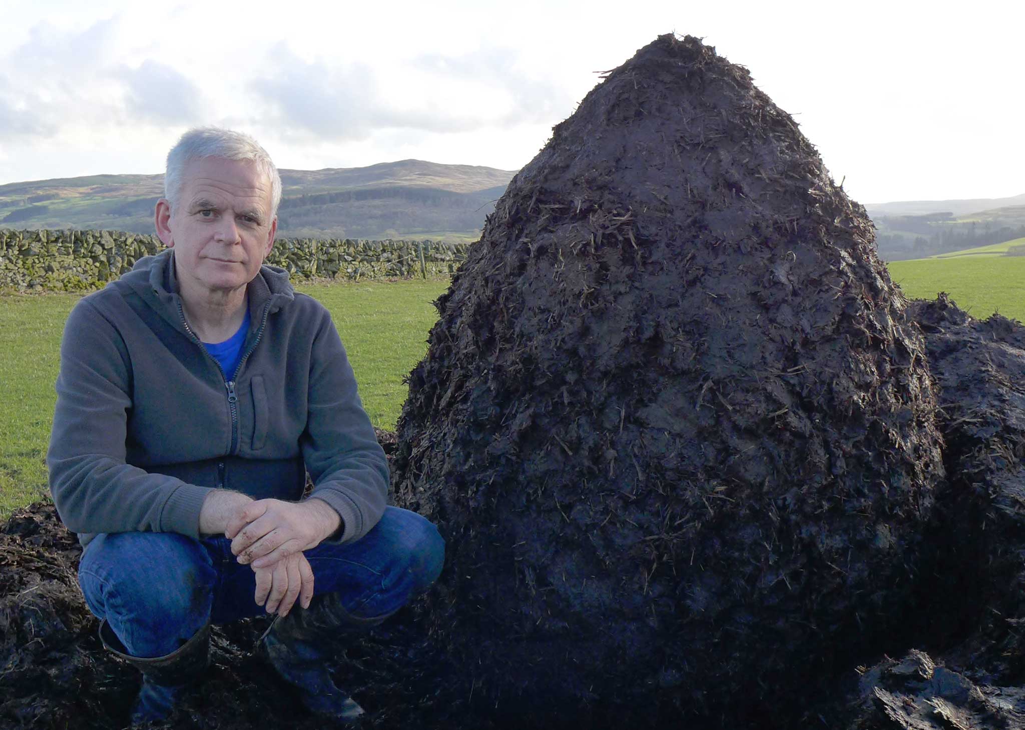 Pile it on: Andy Goldsworthy with a muck heap cairn in Dumfriesshire