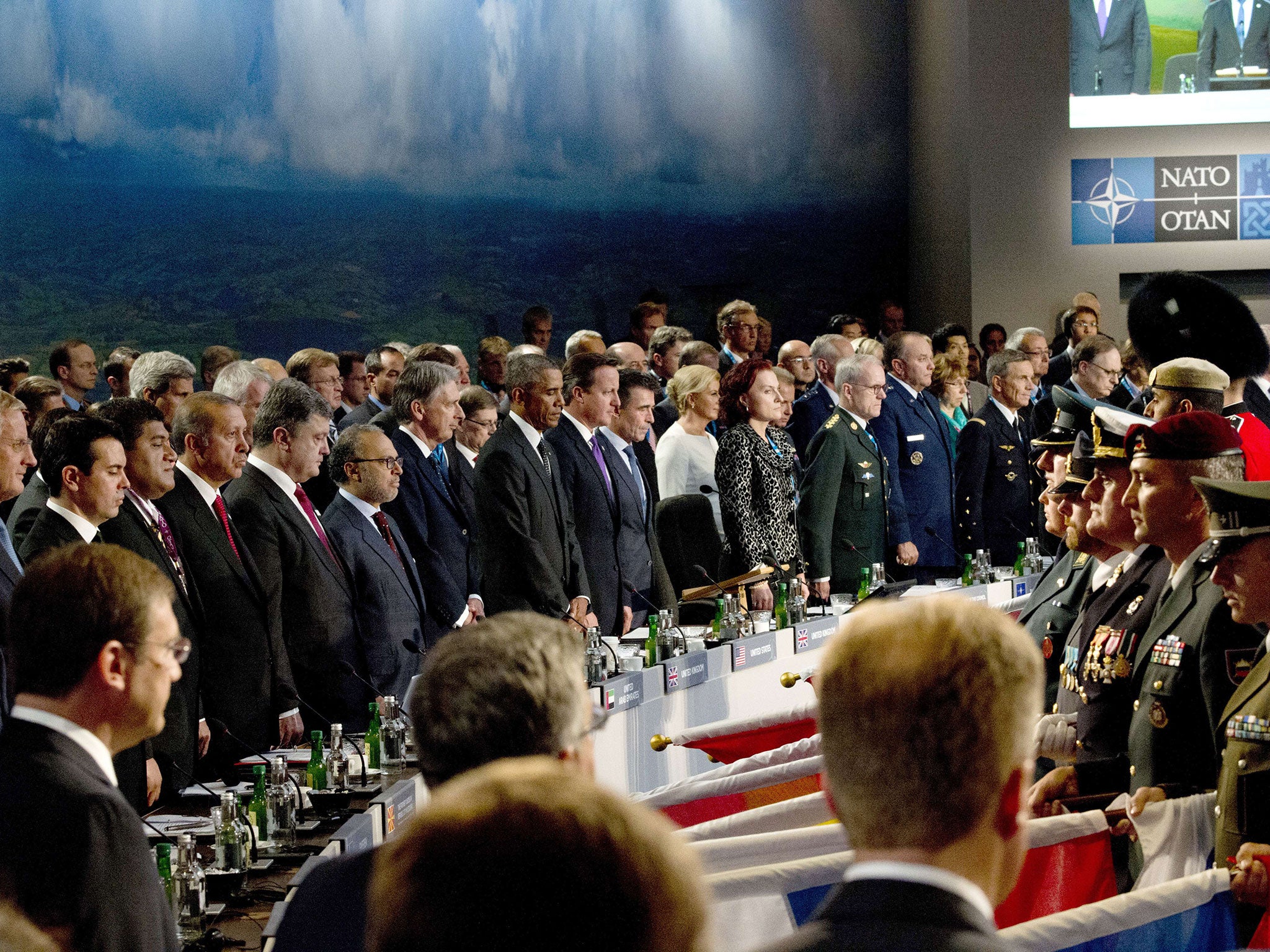 World leaders stand for a moment of silence for killed service members in Afghanistan at the start of a meeting on the country during the NATO 2014 summit at the Celtic Manor Hotel in Newport, South Wales, on September 4, 2014.