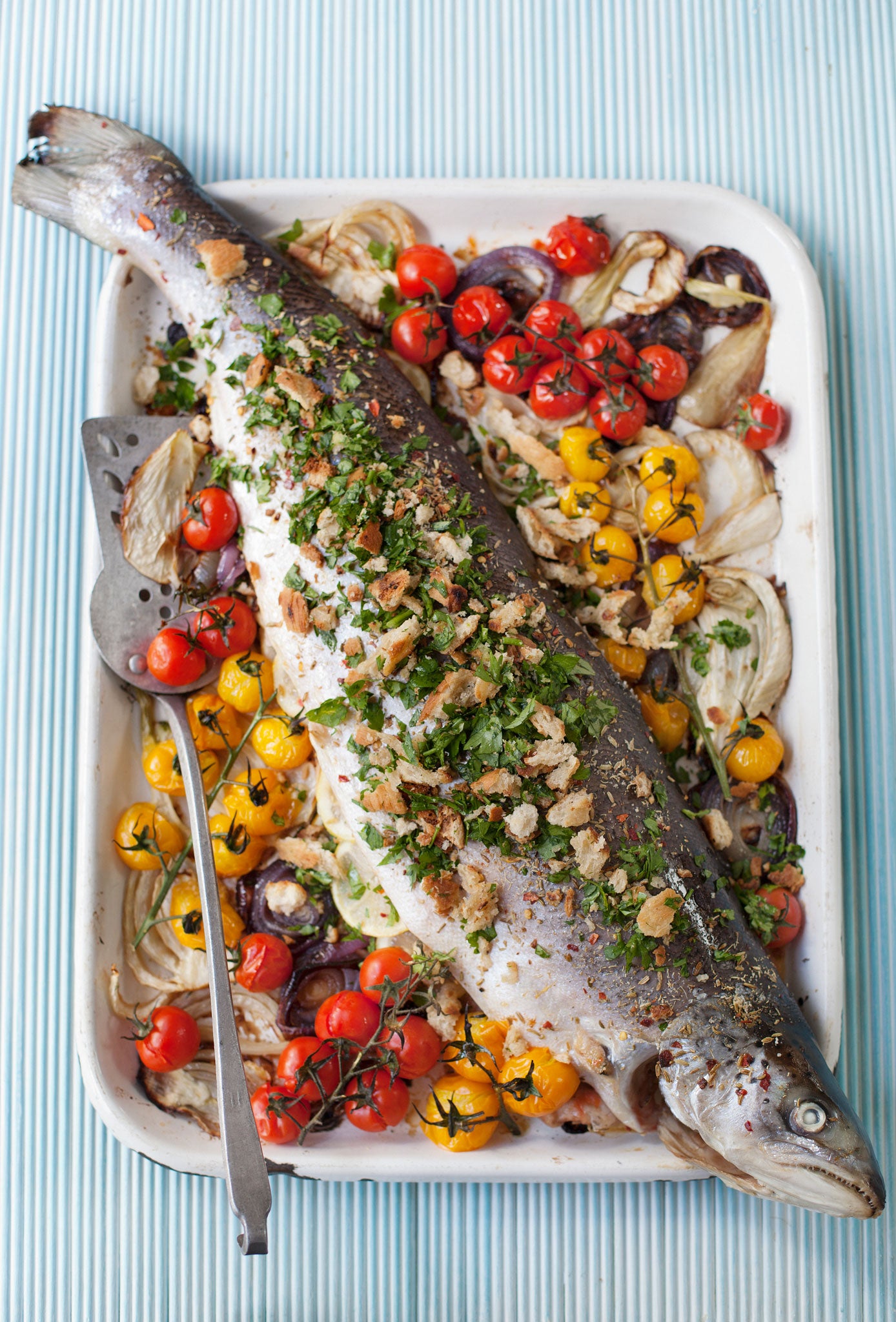 Whole roast salmon with fennel, baby tomatoes and pangrattato