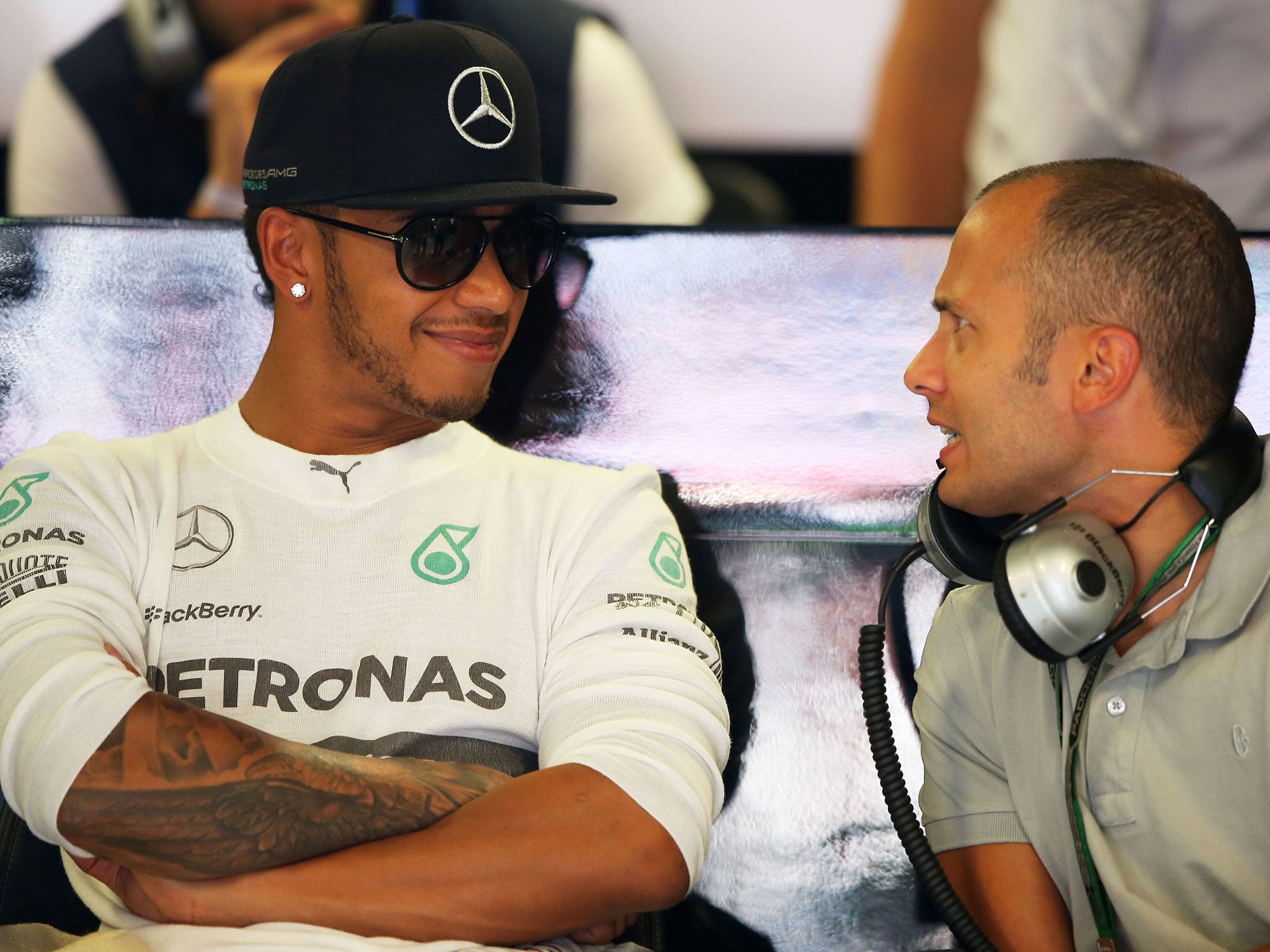 Hamilton relaxes in the garage during Friday practice