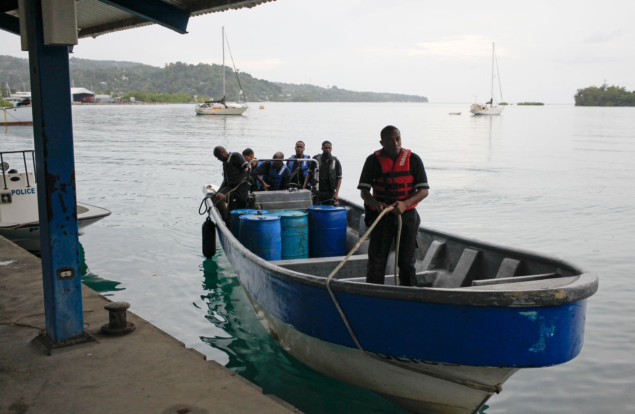 Members of Jamaica's Marine Police return to port after conducting a search