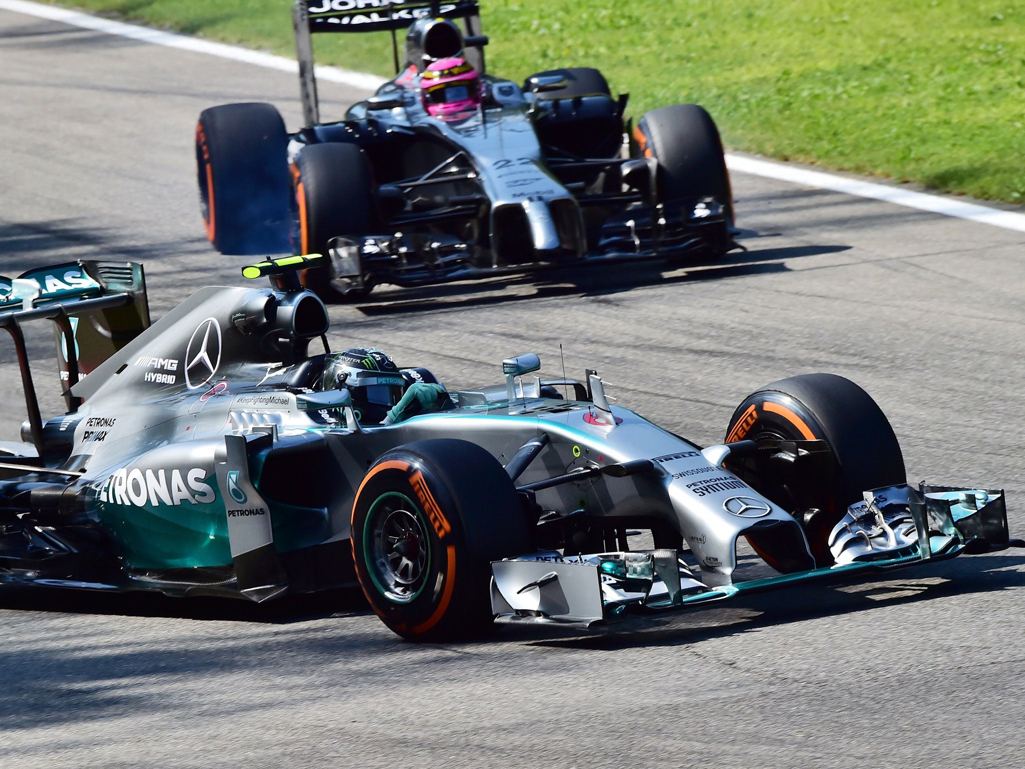 Rosberg turns into the second chicane ahead of a locked-up Button