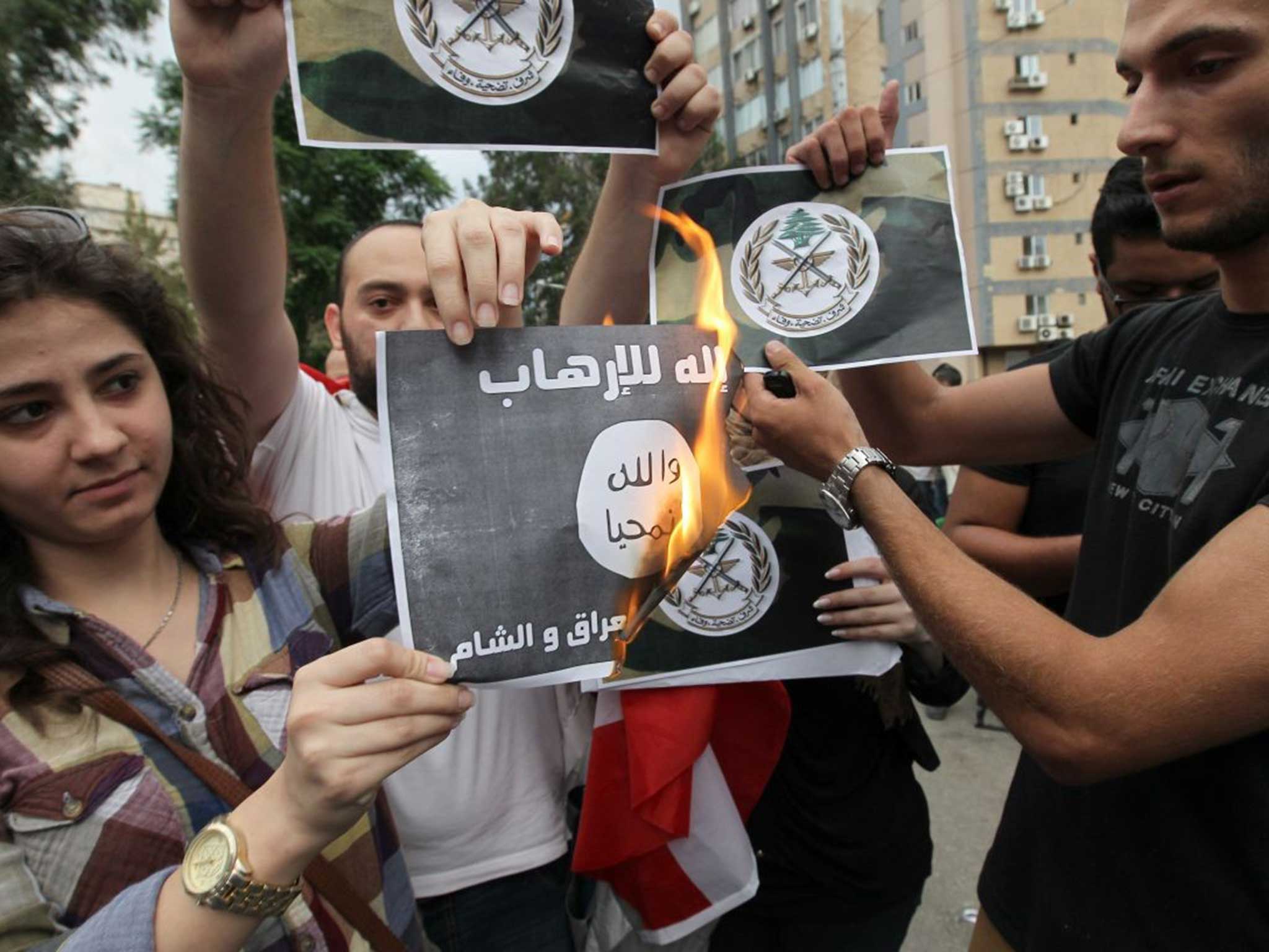 Fired up: Lebanese activists protest by burning paper Islamist flags in Beirut