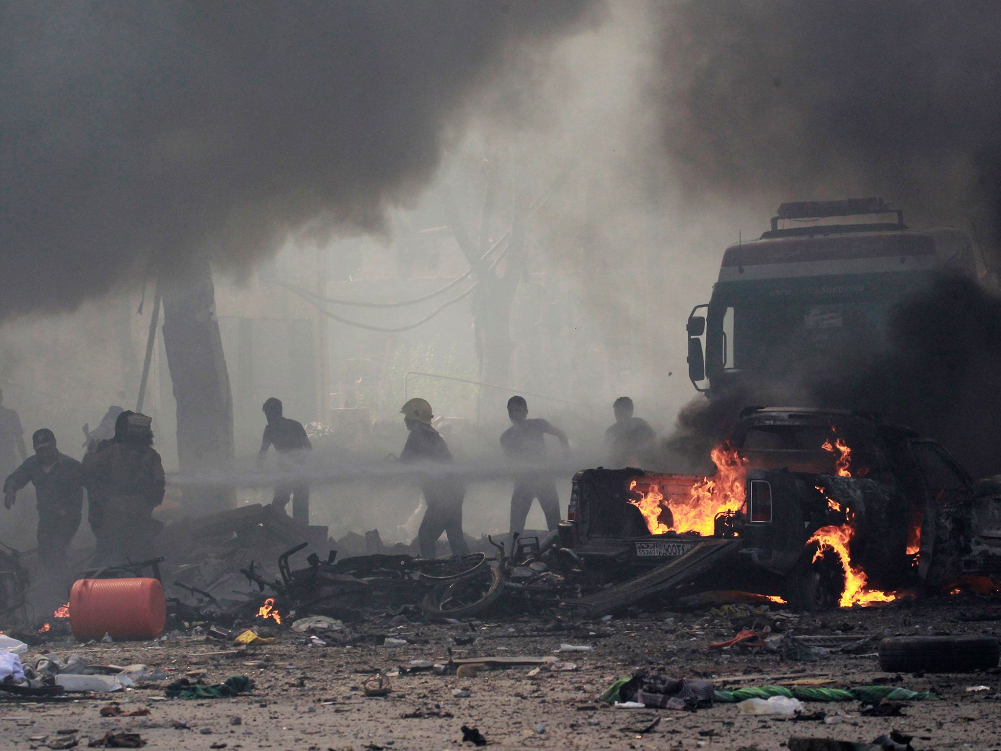 Syrians tackle a fire in Raqqa, after what activists said was an air strike by forces loyal to President Bashar al-Assad