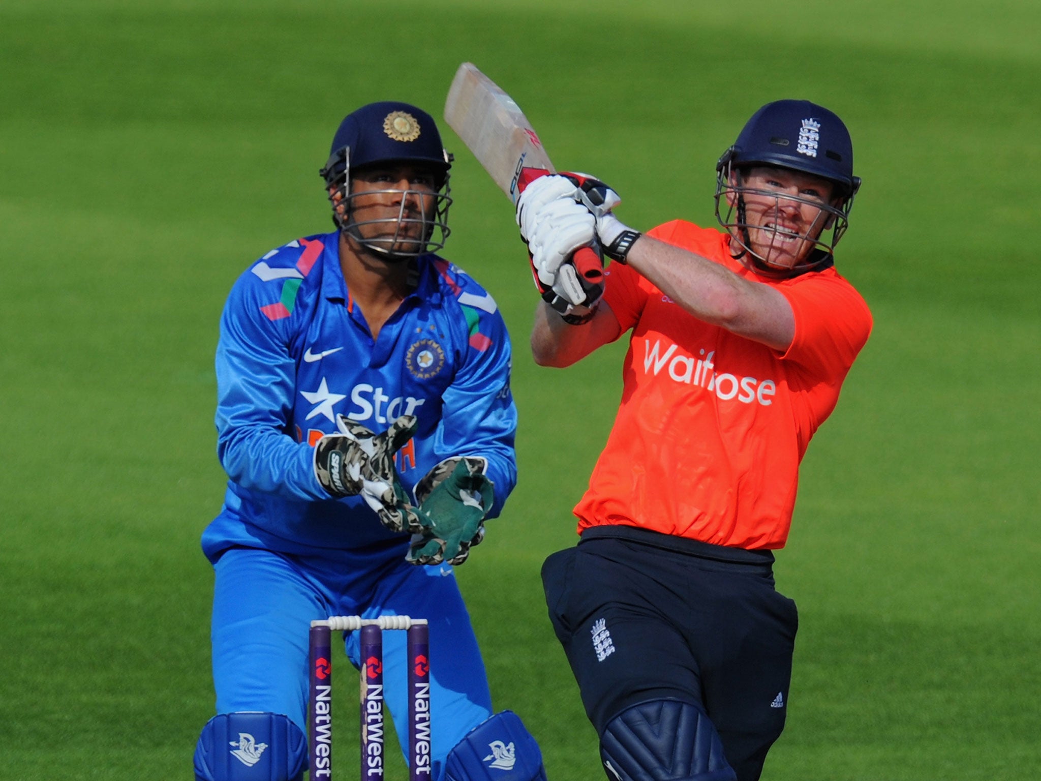 England batsman Eoin Morgan hits a straight six watched by MS Dhoni