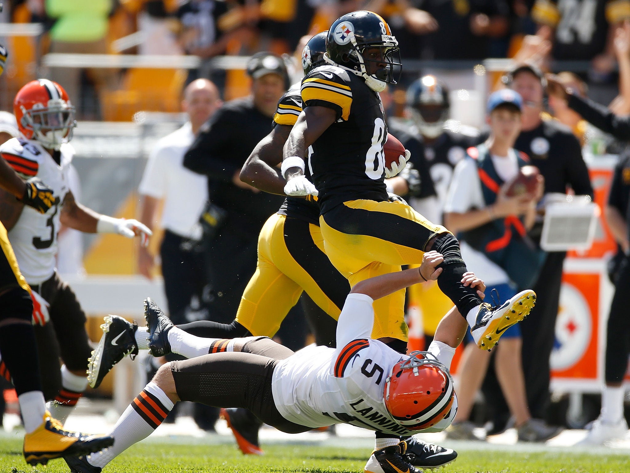 Antonio Brown attempts to hurdle Spencer Lanning