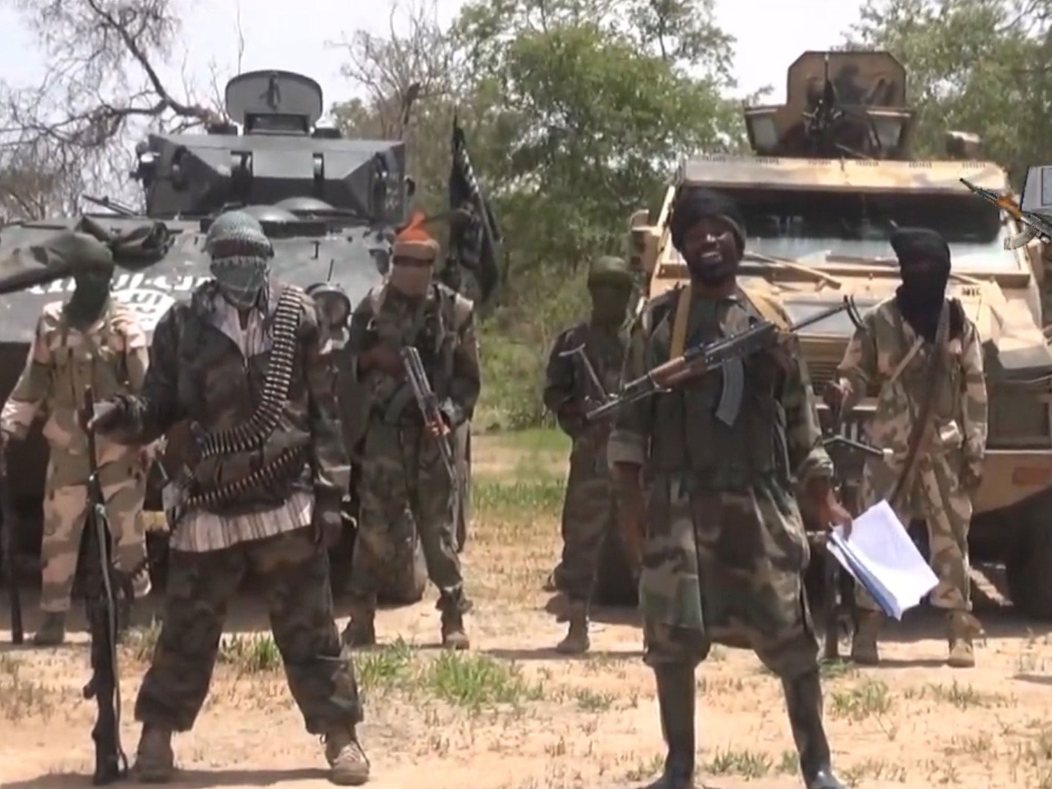 The leader of Boko Haram, Abubakar Shekau (with papers) in a video grab taken in July