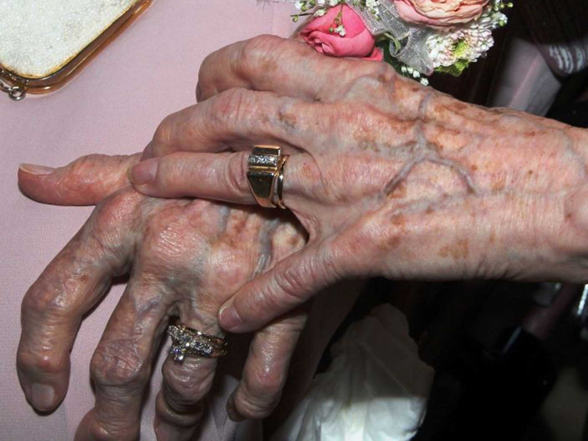 The couple hold hands after the ceremony