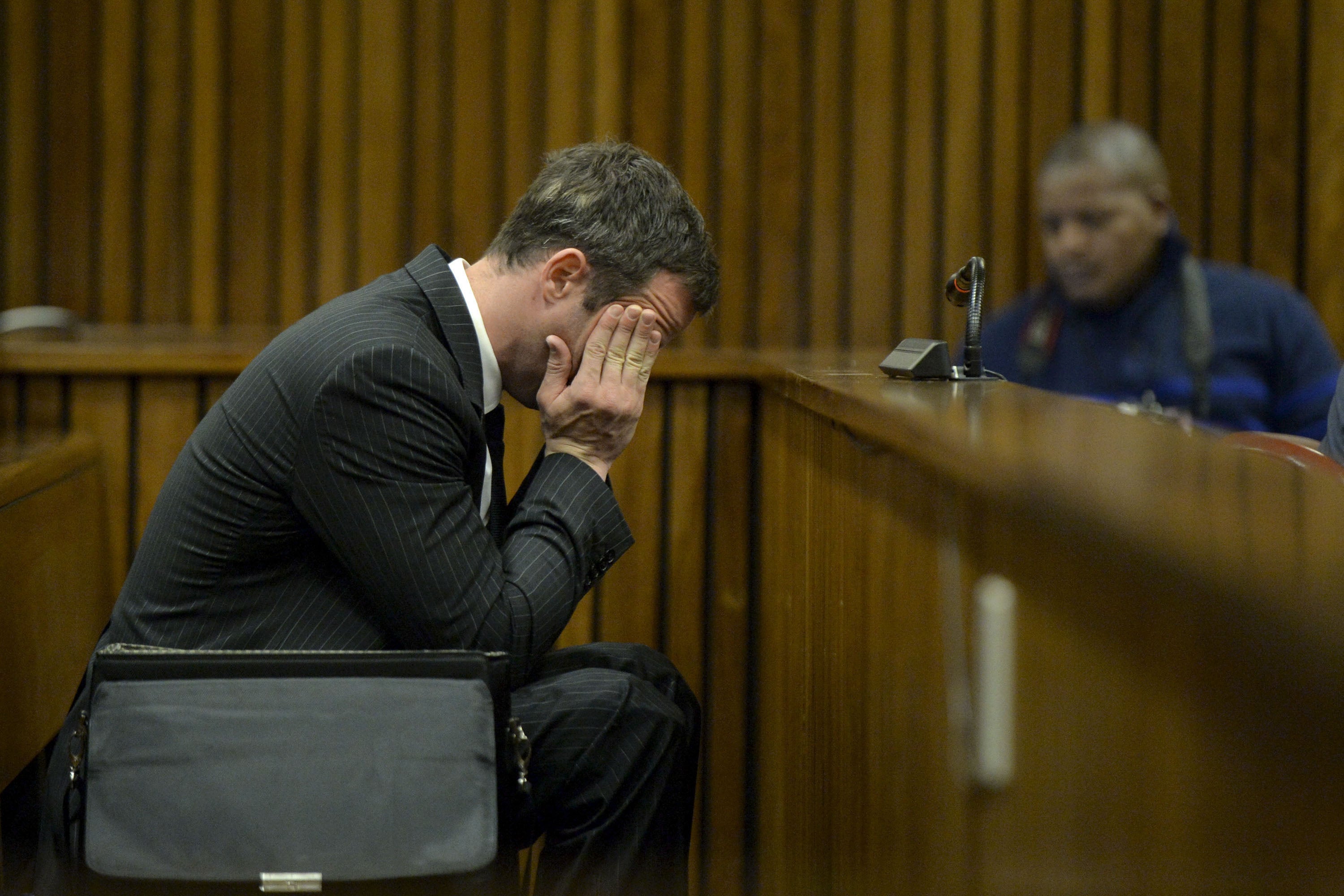 Oscar Pistorius sits in the dock during closing arguments in his murder trial in the Pretoria High Court on August 8, 2014, in Pretoria, South Africa. Oscar Pistorius stands accused of the murder of his girlfriend, Reeva Steenkamp, on February 14, 2013.