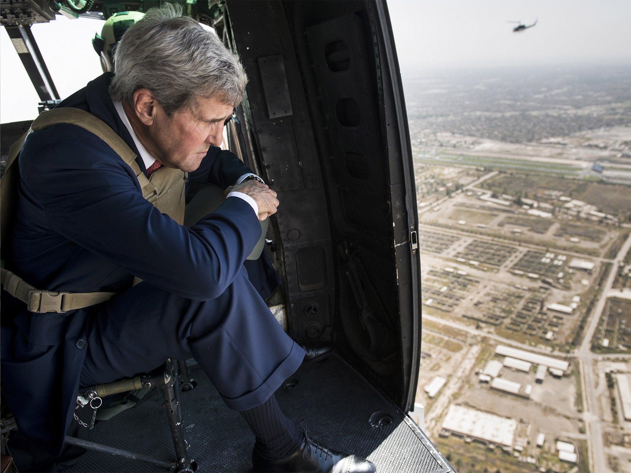 United States Secretary of State John Kerry looks out over Baghdad from a helicopter delivering him to a meeting with the newly appointed Iraqi government