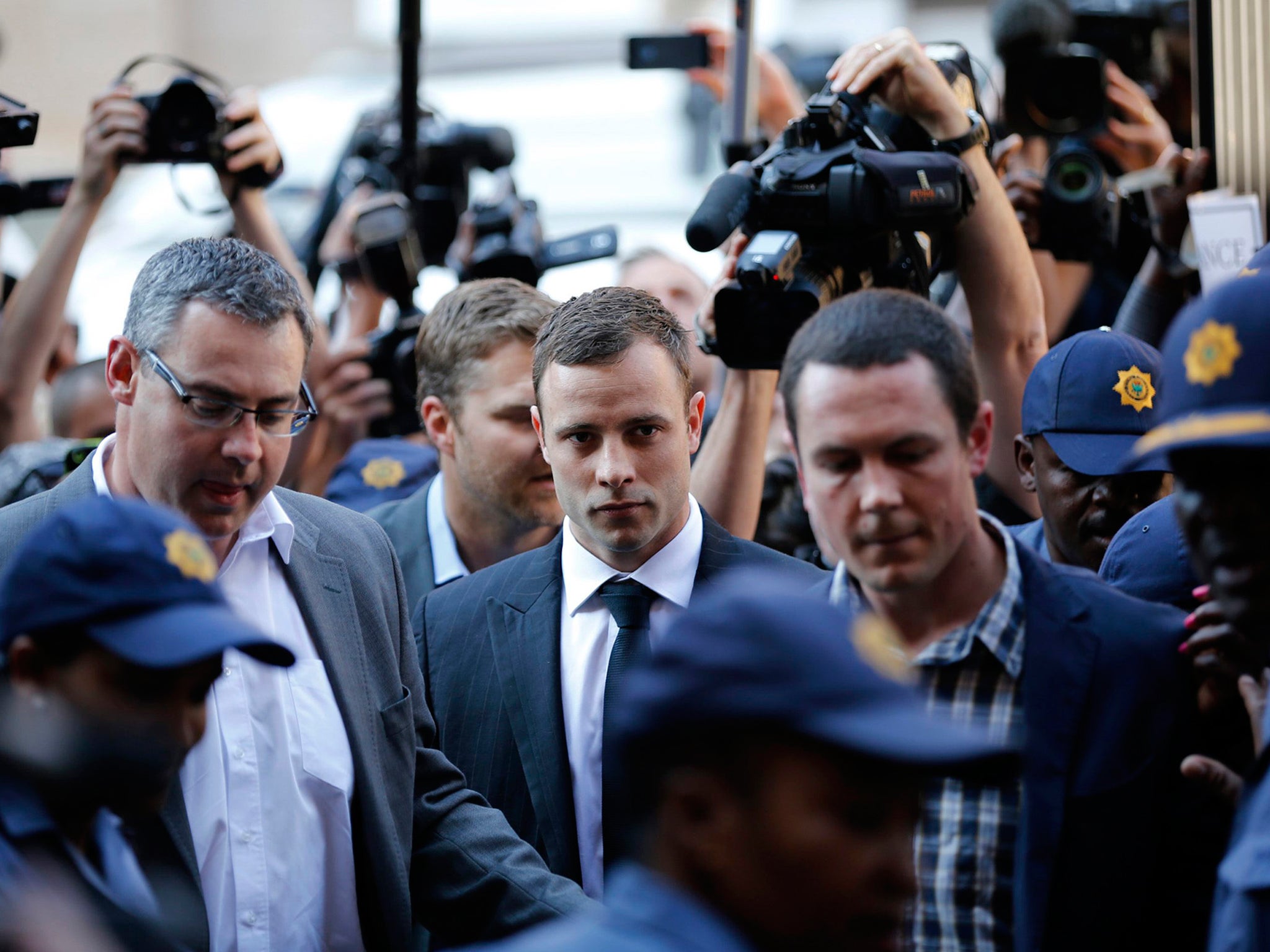 Oscar Pistorius arrives for the verdict in his murder trial at the high court in Pretoria