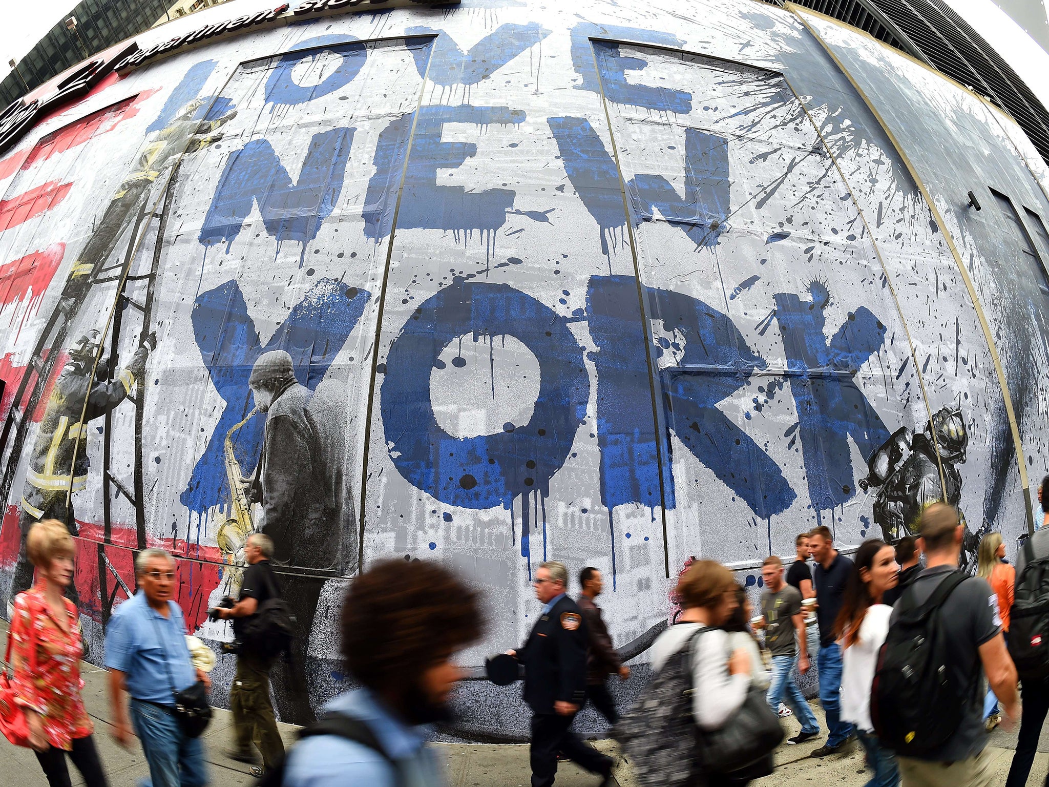 People walk past a massive 9/11 mural in New York